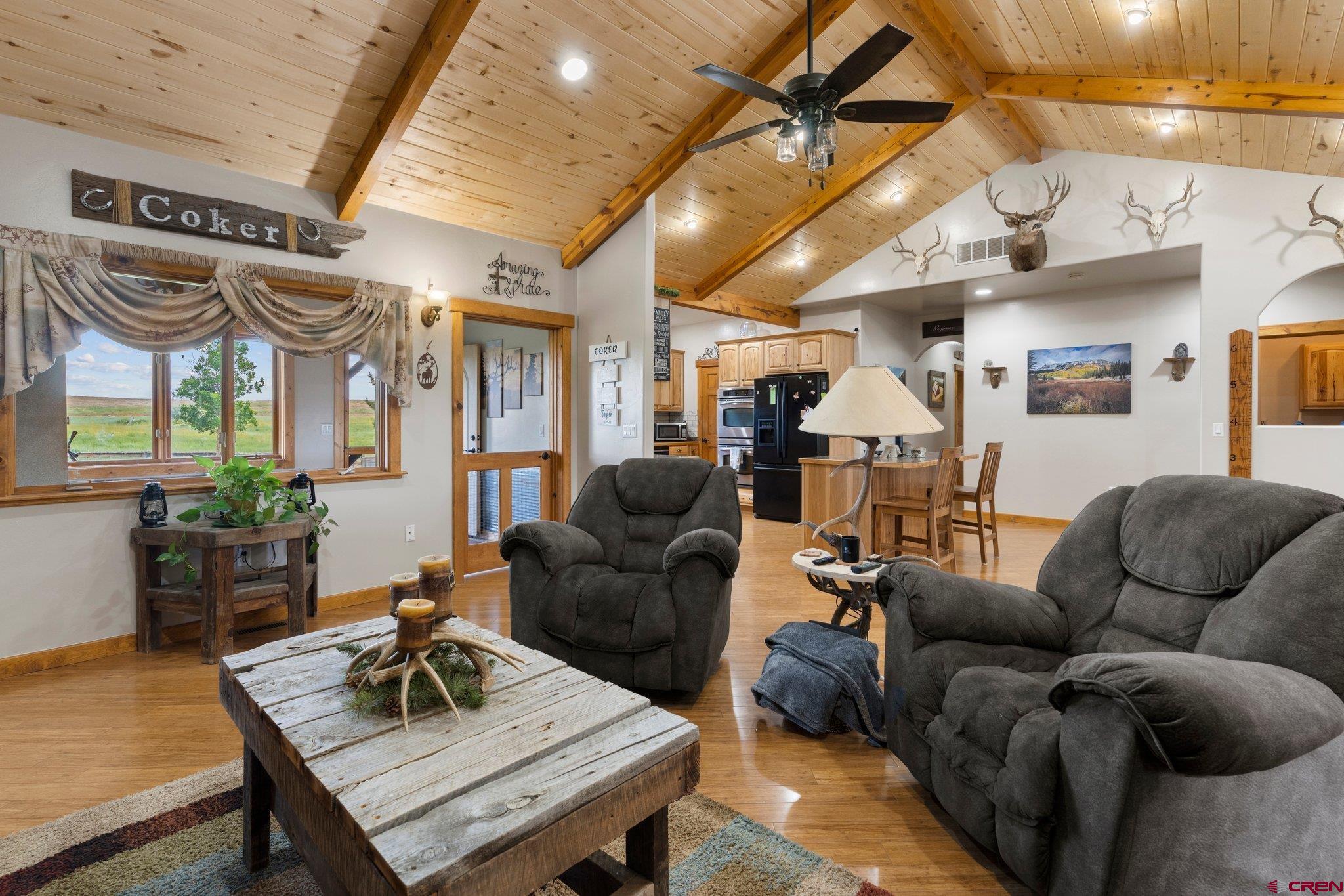 16132 Ee Road Pleasant View, CO 81331 - Photo 13 of 35 a living room with furniture a ceiling fan and a rug