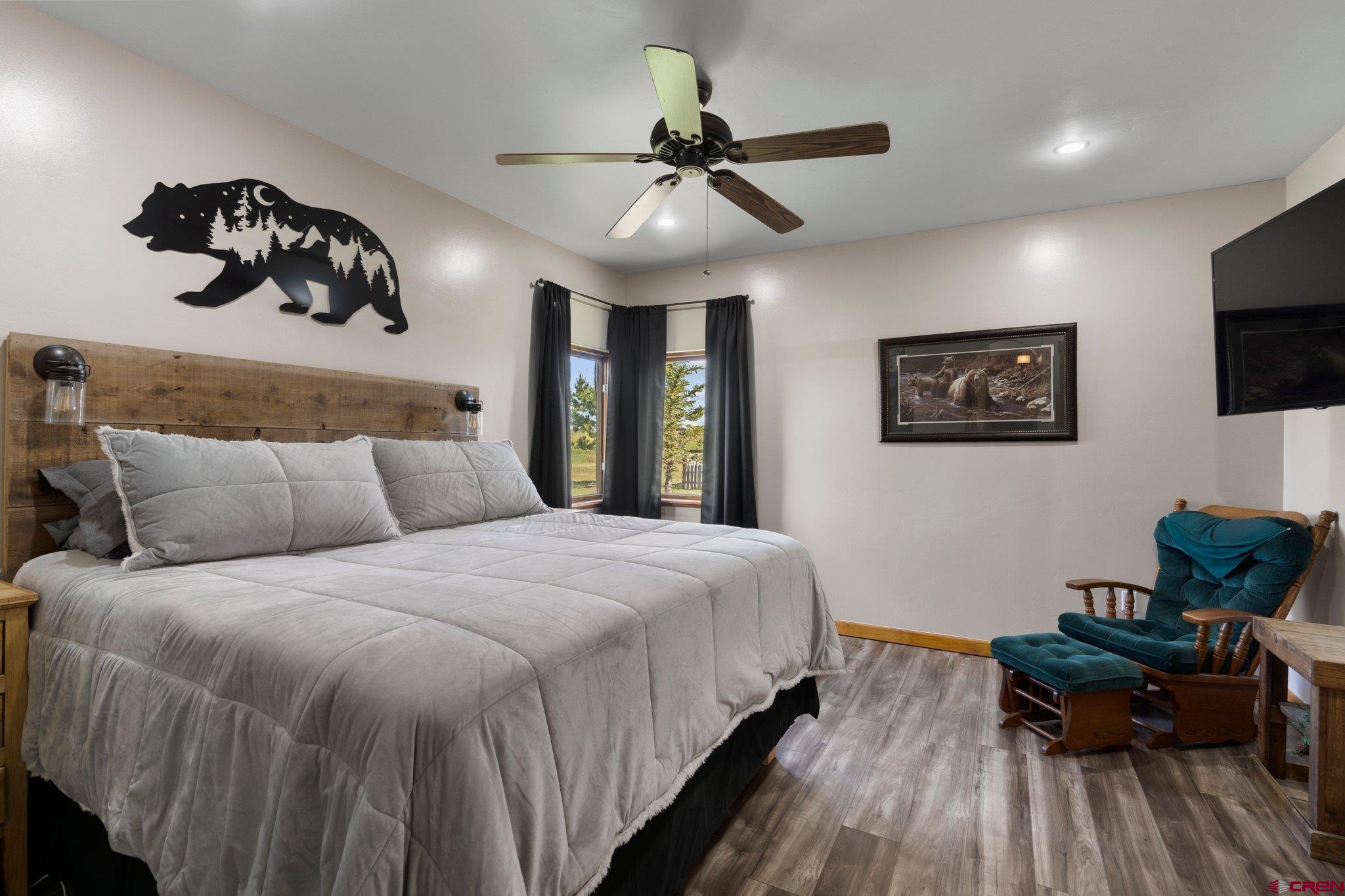 16132 Ee Road Pleasant View, CO 81331 - Photo 16 of 35 a bedroom with bed and a chandelier