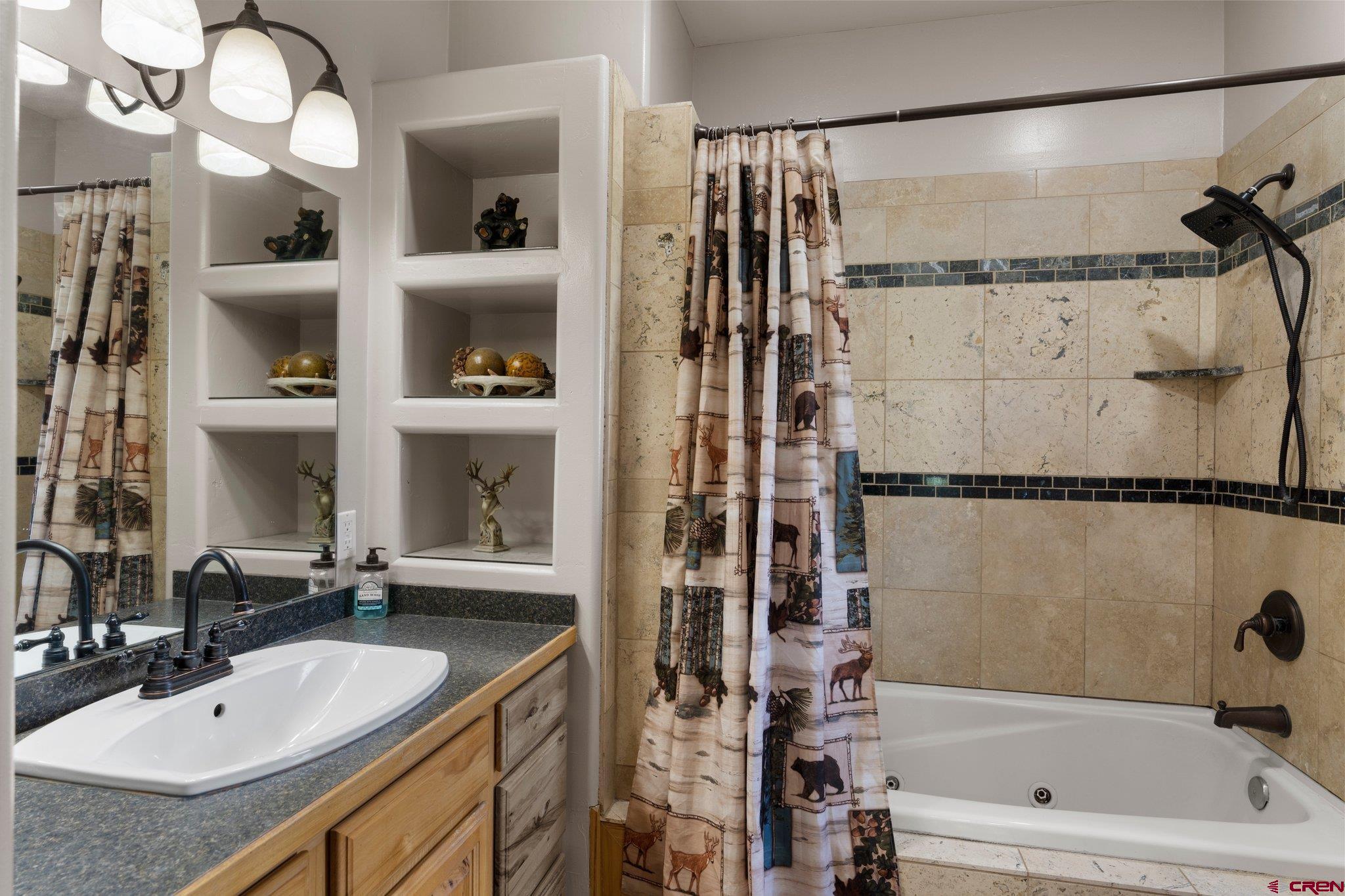 16132 Ee Road Pleasant View, CO 81331 - Photo 17 of 35 a bathroom with a granite countertop sink a mirror and shower