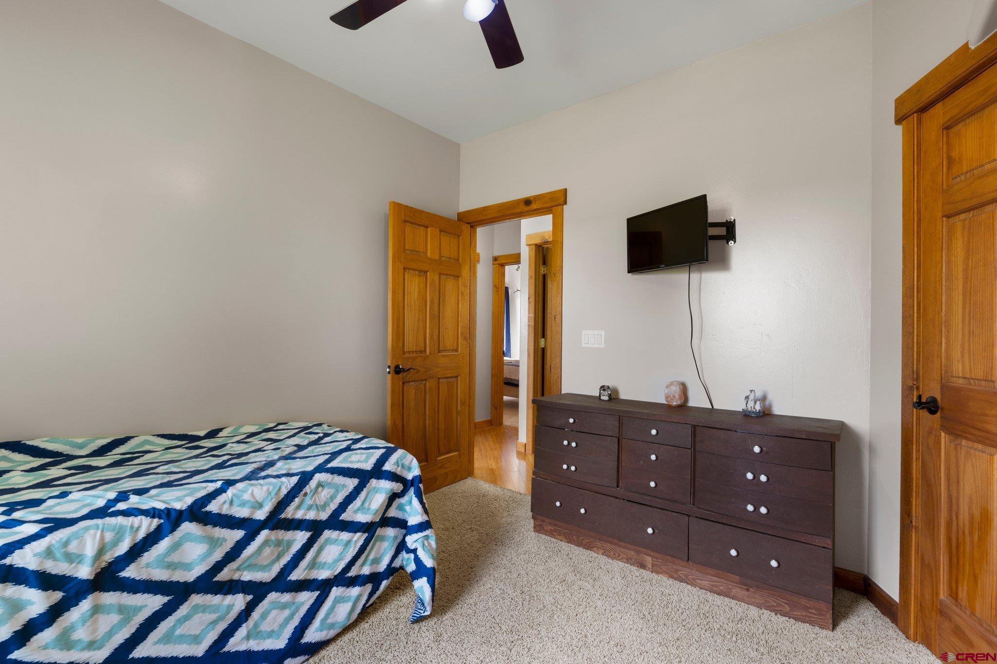16132 Ee Road Pleasant View, CO 81331 - Photo 19 of 35 a bedroom with a bed and flat screen tv