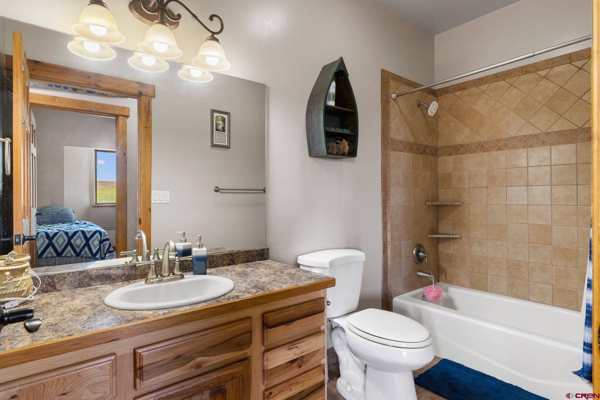 16132 Ee Road Pleasant View, CO 81331 - Photo 20 of 35 a bathroom with a sink toilet and shower