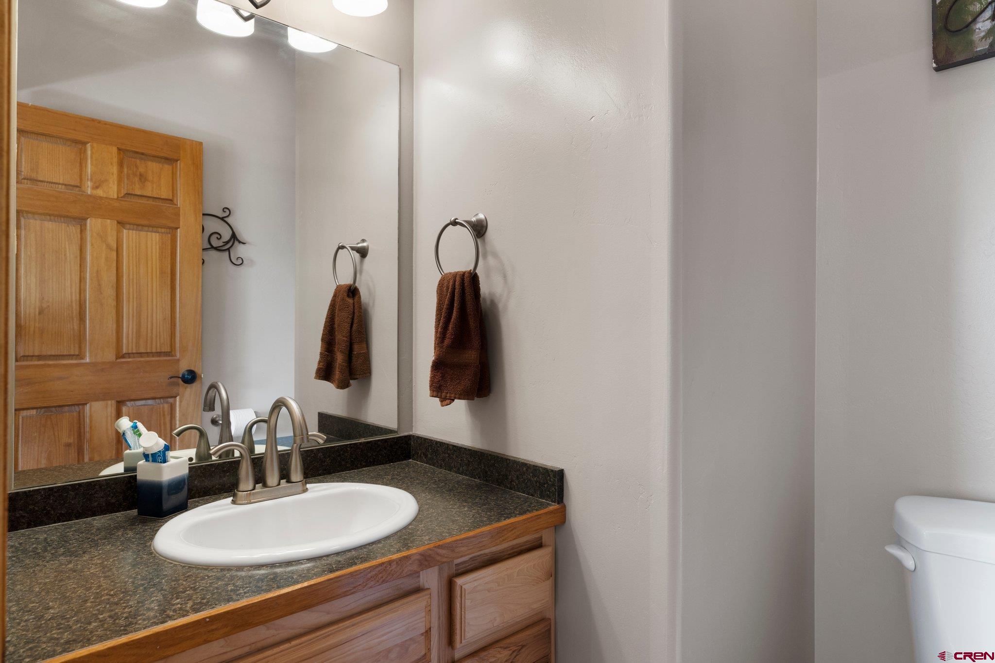 16132 Ee Road Pleasant View, CO 81331 - Photo 25 of 35 a bathroom with a sink and a mirror