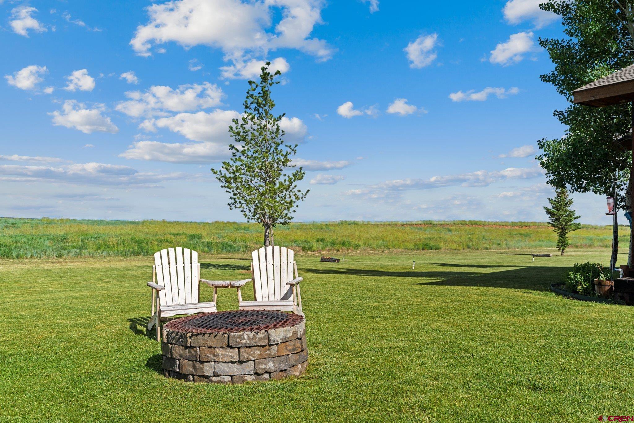 16132 Ee Road Pleasant View, CO 81331 - Photo 31 of 35 a view of a table and chairs in the garden