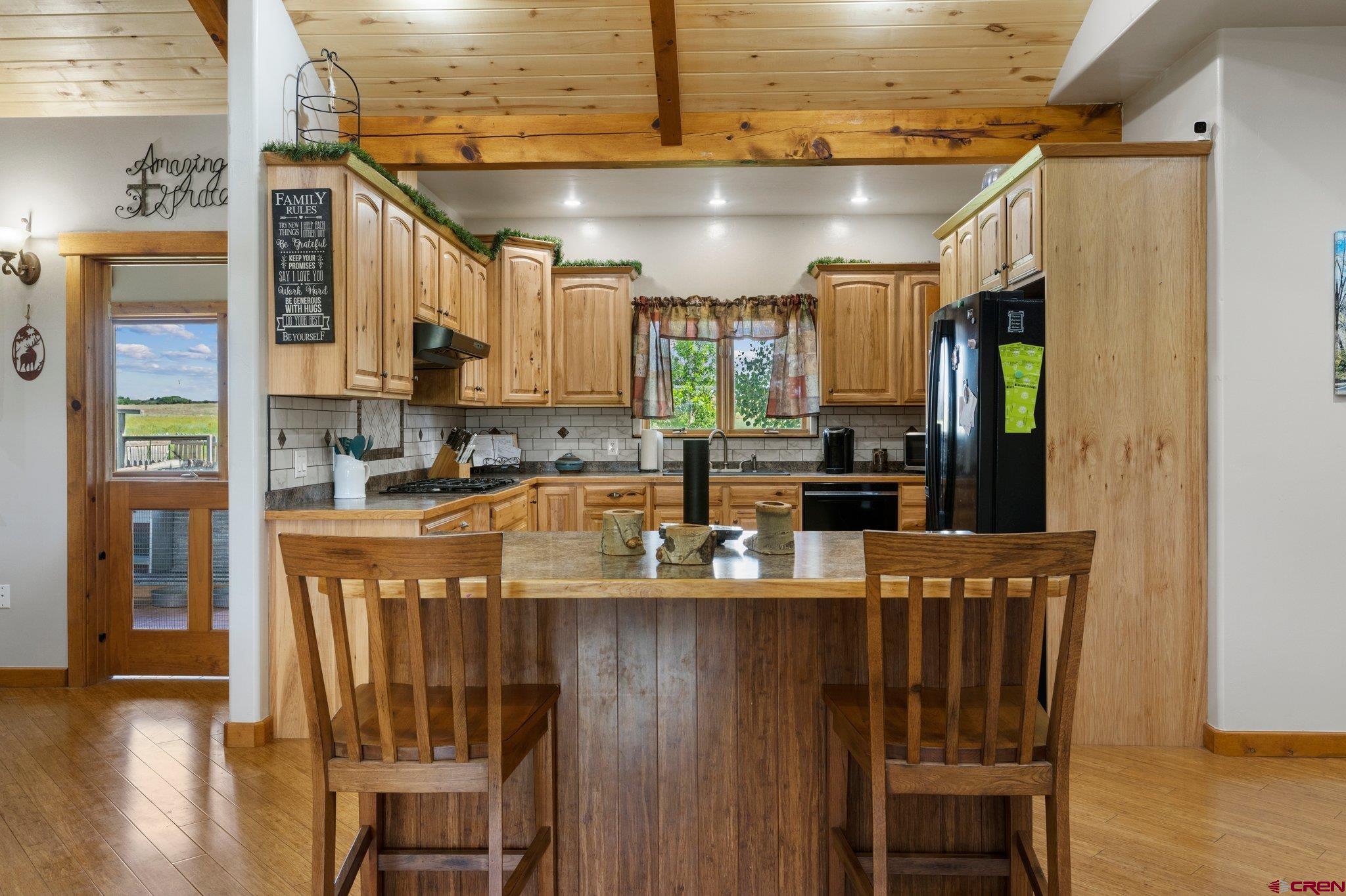16132 Ee Road Pleasant View, CO 81331 - Photo 7 of 35 a kitchen with stainless steel appliances granite countertop a refrigerator a stove and a sink with granite countertops