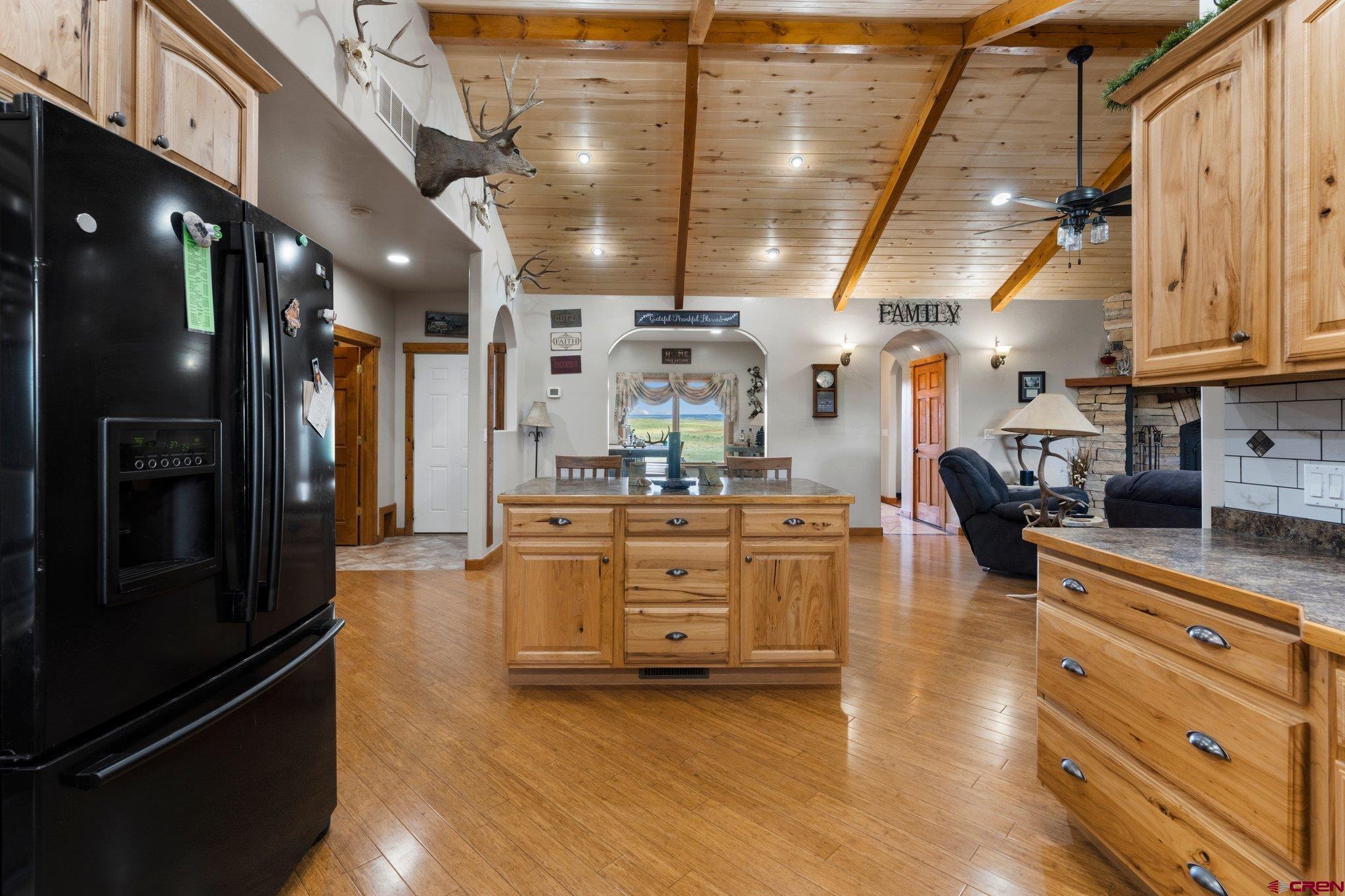 16132 Ee Road Pleasant View, CO 81331 - Photo 8 of 35 a kitchen with stainless steel appliances kitchen island granite countertop a refrigerator and a stove