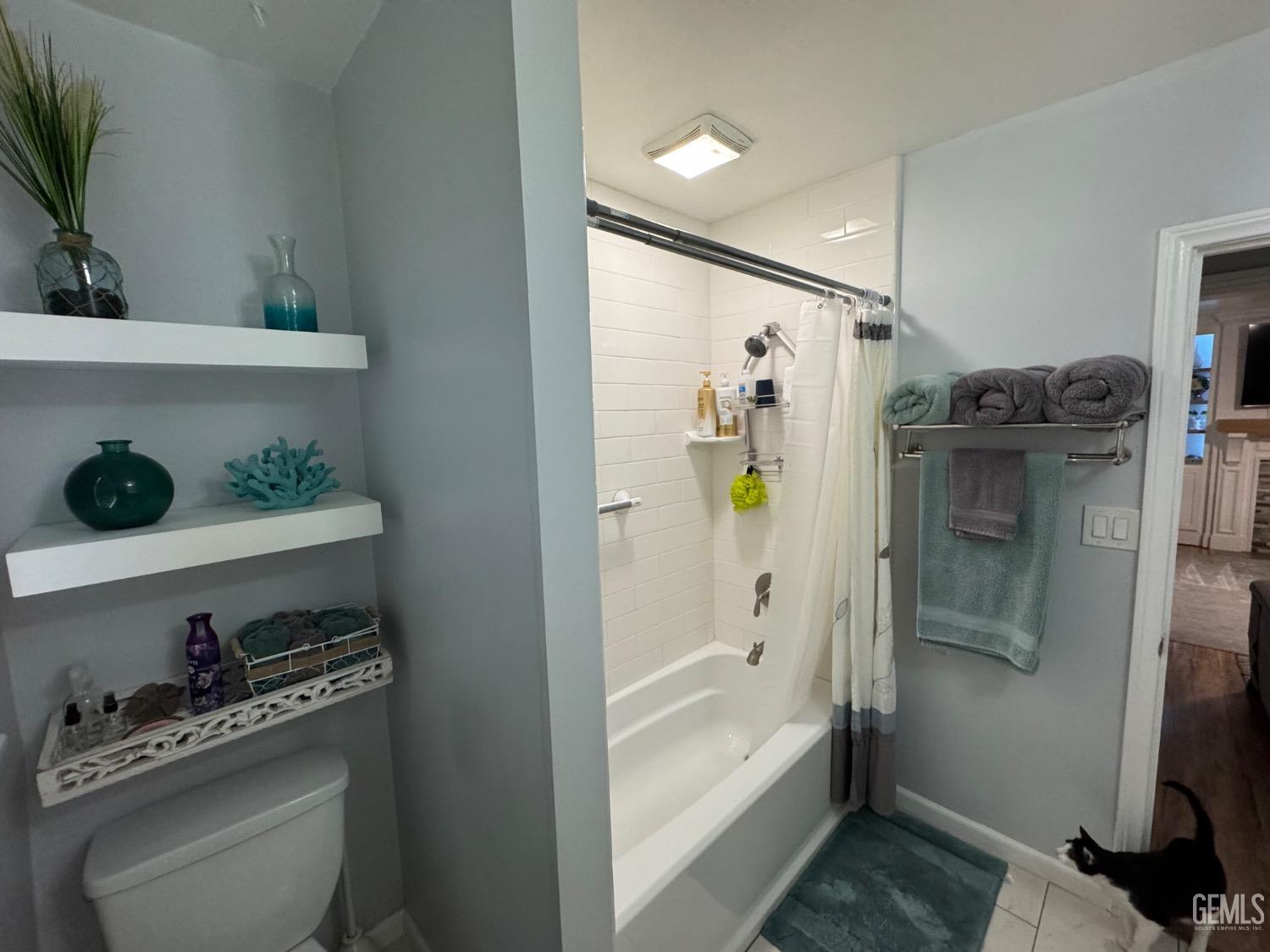 Undisclosed Address Bakersfield, CA 93304 - Photo 13 of 19 a bathroom with a shower and a tub