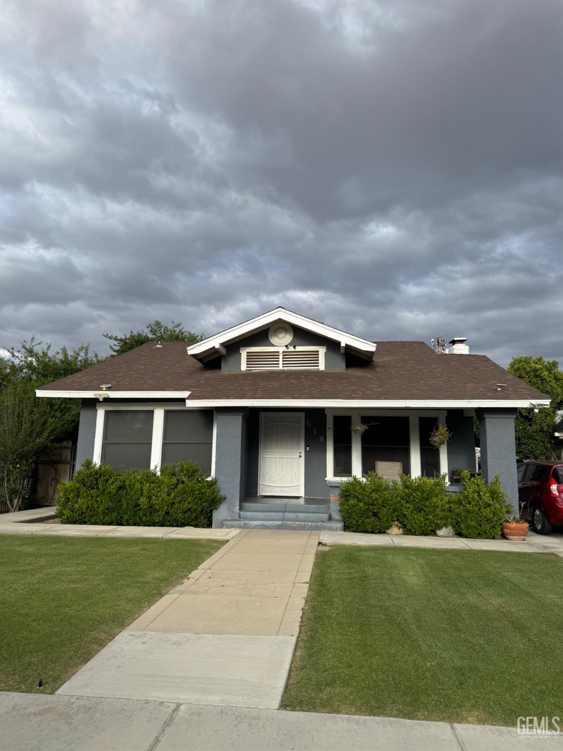 Undisclosed Address Bakersfield, CA 93304 - Photo 2 of 19 front view of a house with a yard