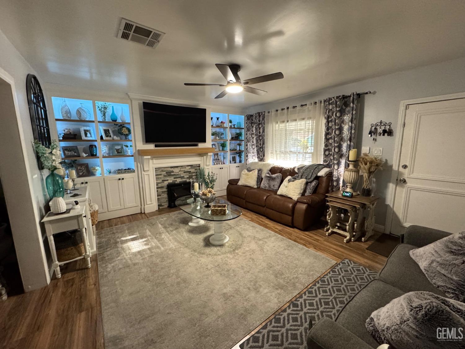 Undisclosed Address Bakersfield, CA 93304 - Photo 3 of 19 a living room with furniture a flat screen tv and a fireplace