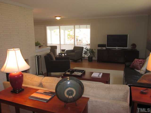 2031 Reaves Drive Raleigh, NC 27608 - Photo 25 of 25 This view is taken from the foyer looking into the family/living room and dining room area! Very open floor plan! Den/Family/Great Room