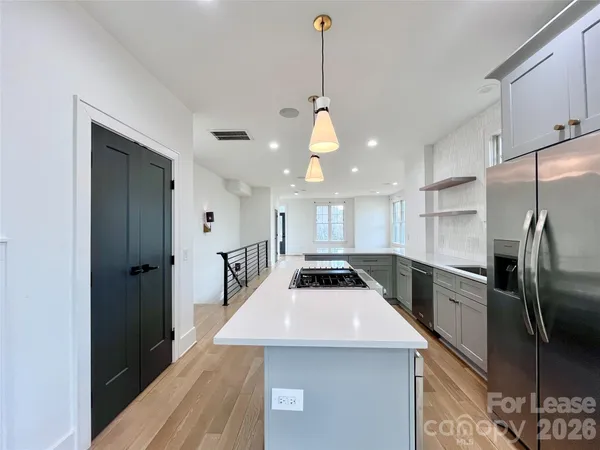 a kitchen with a refrigerator a sink and cabinets