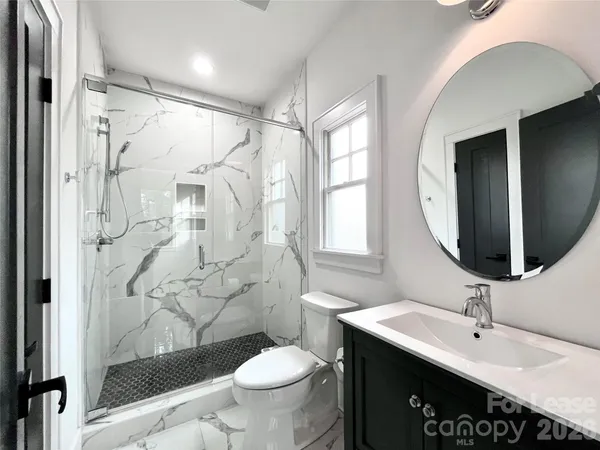 a bathroom with a sink toilet and shower