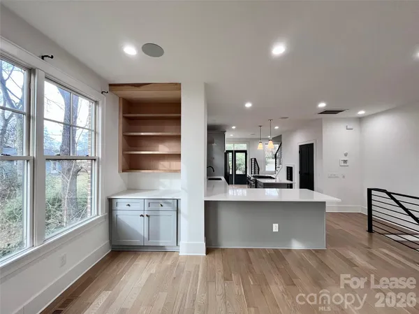 a view of kitchen with wooden floor and electronic appliances