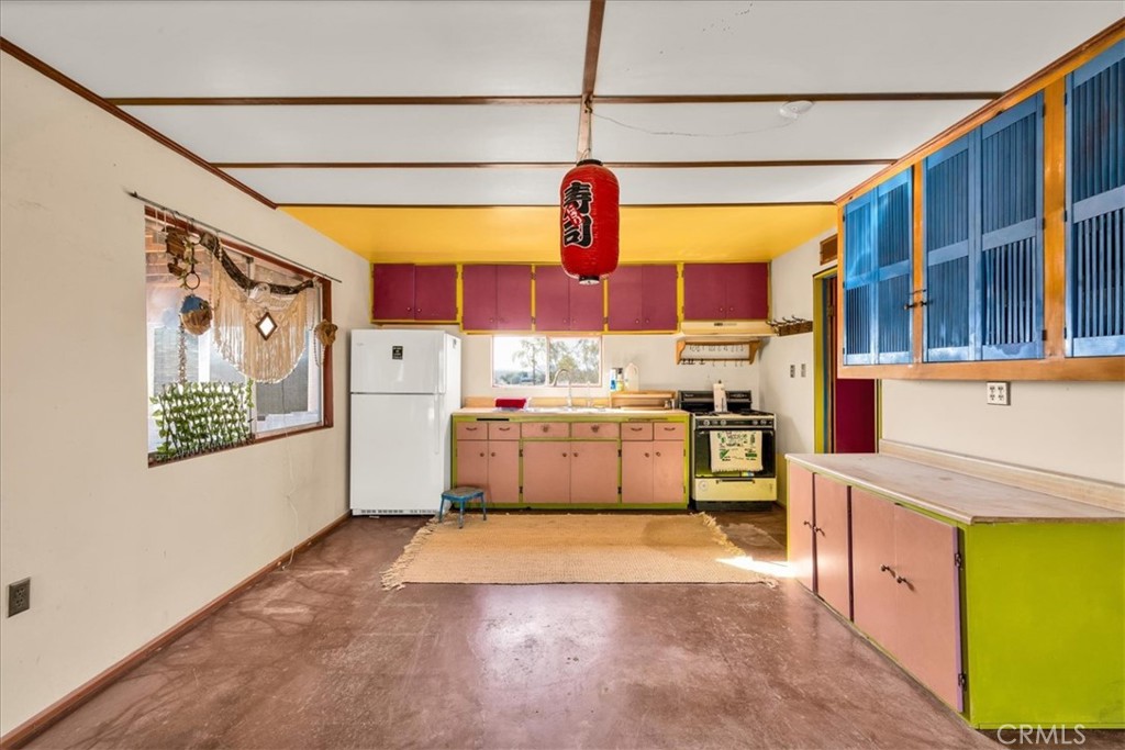 64720 Sonora Road Joshua Tree, CA 92252 - Photo 6 of 31 a kitchen with stainless steel appliances granite countertop a stove and cabinets