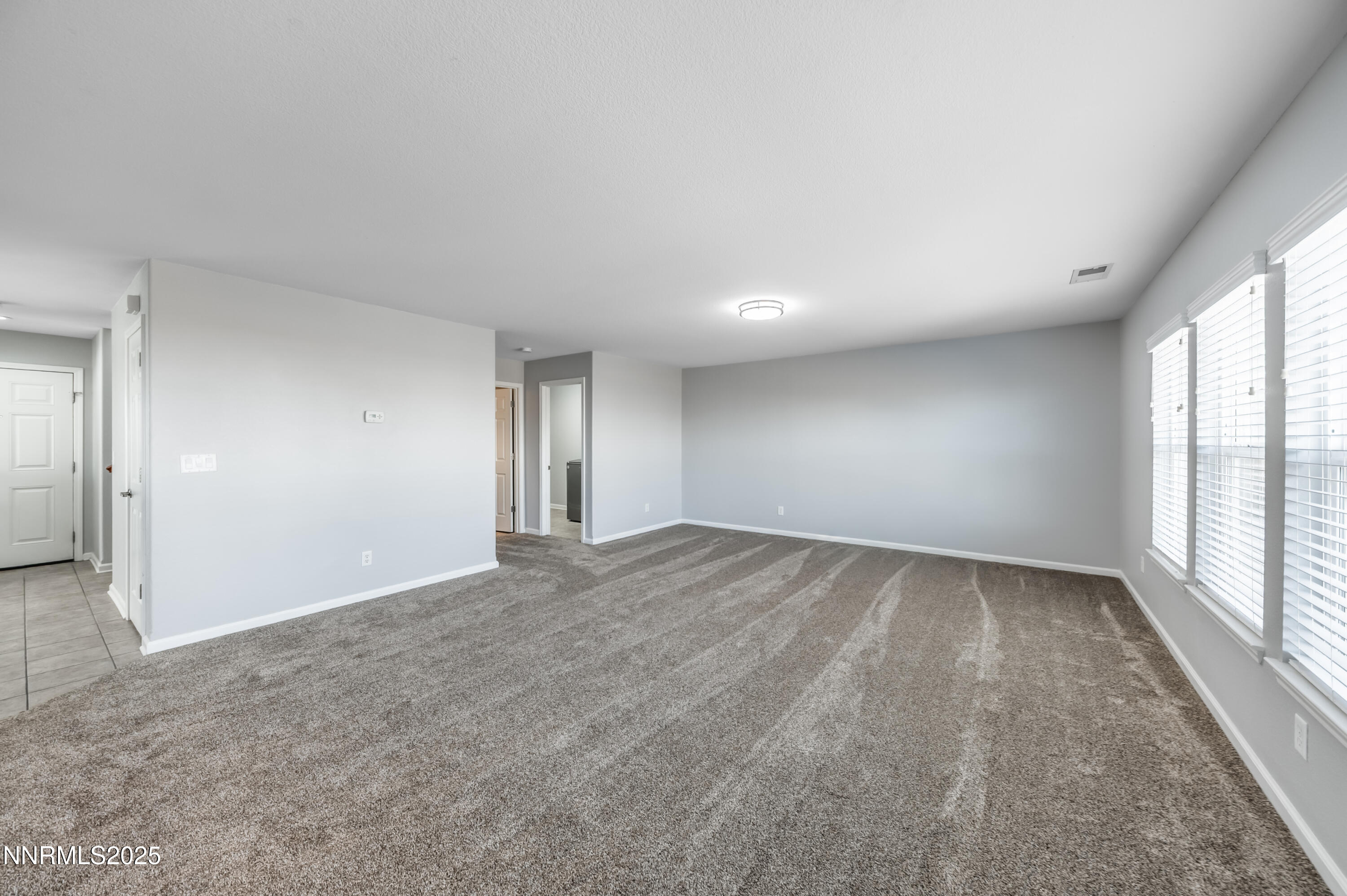 8905 Convair Way Reno, NV 89506 - Photo 16 of 38 wooden floor in an empty room with a window