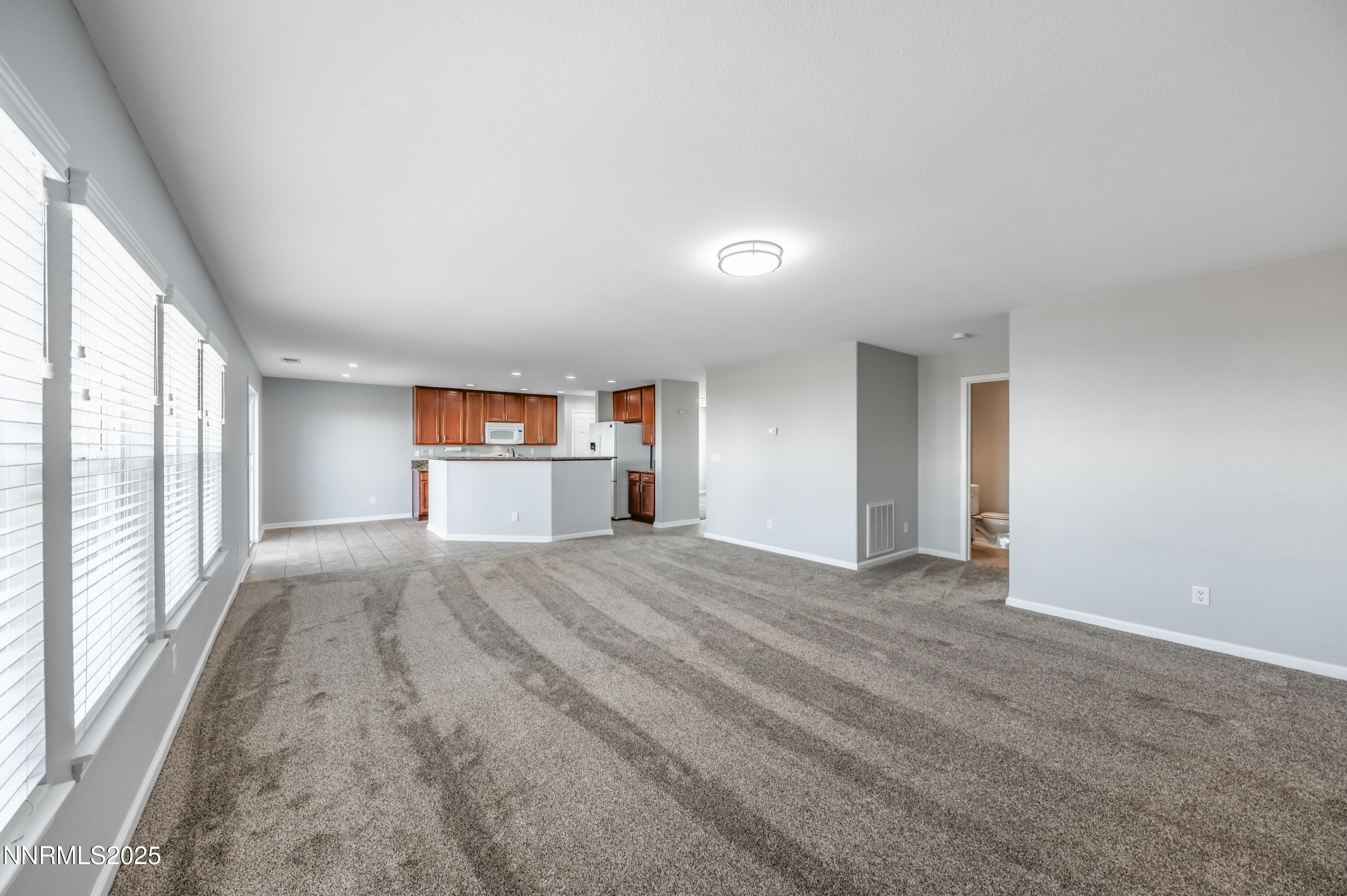 8905 Convair Way Reno, NV 89506 - Photo 19 of 38 a view of empty room with a fireplace and windows