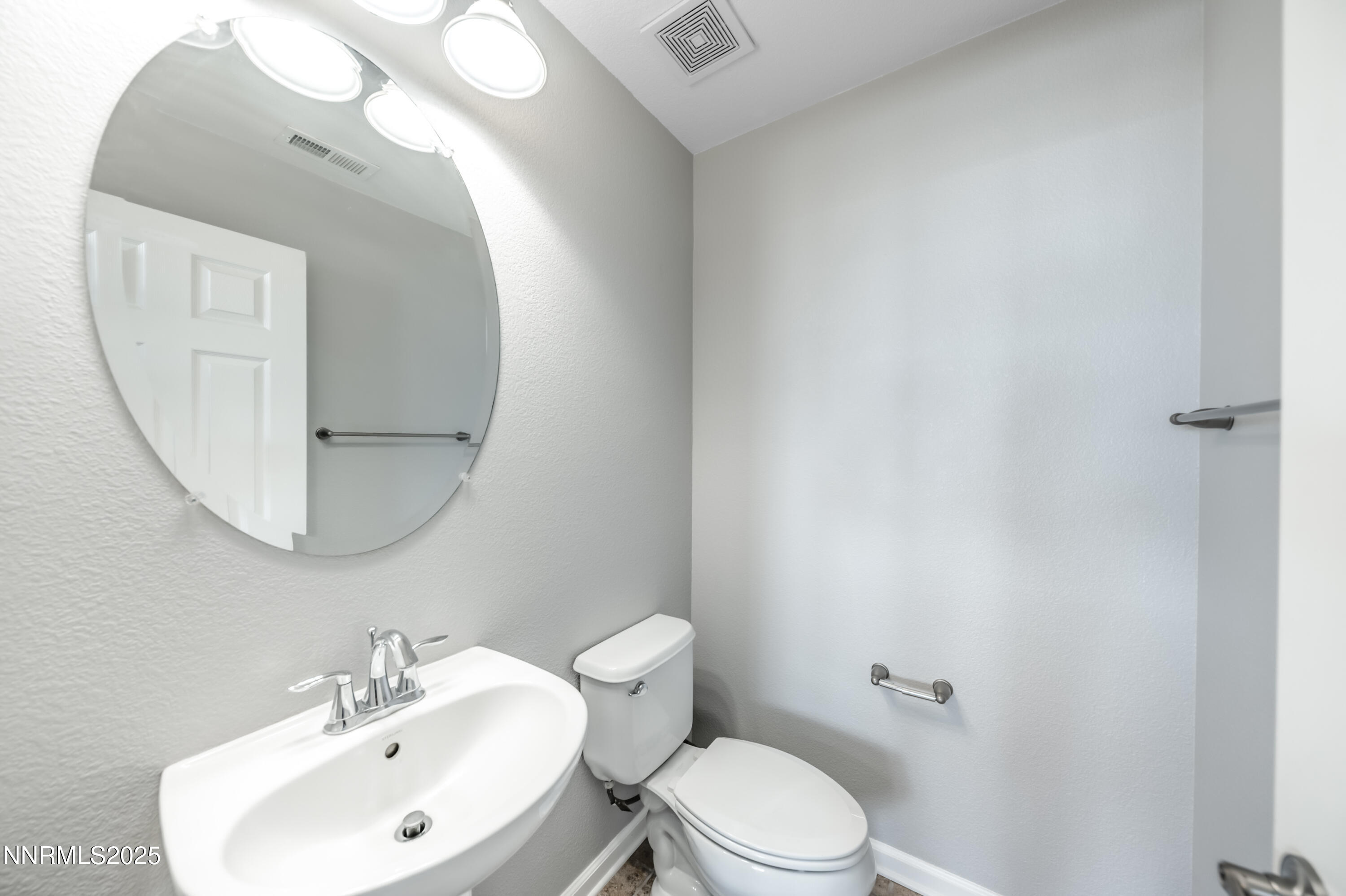 8905 Convair Way Reno, NV 89506 - Photo 30 of 38 a bathroom with a sink and mirror with toilet