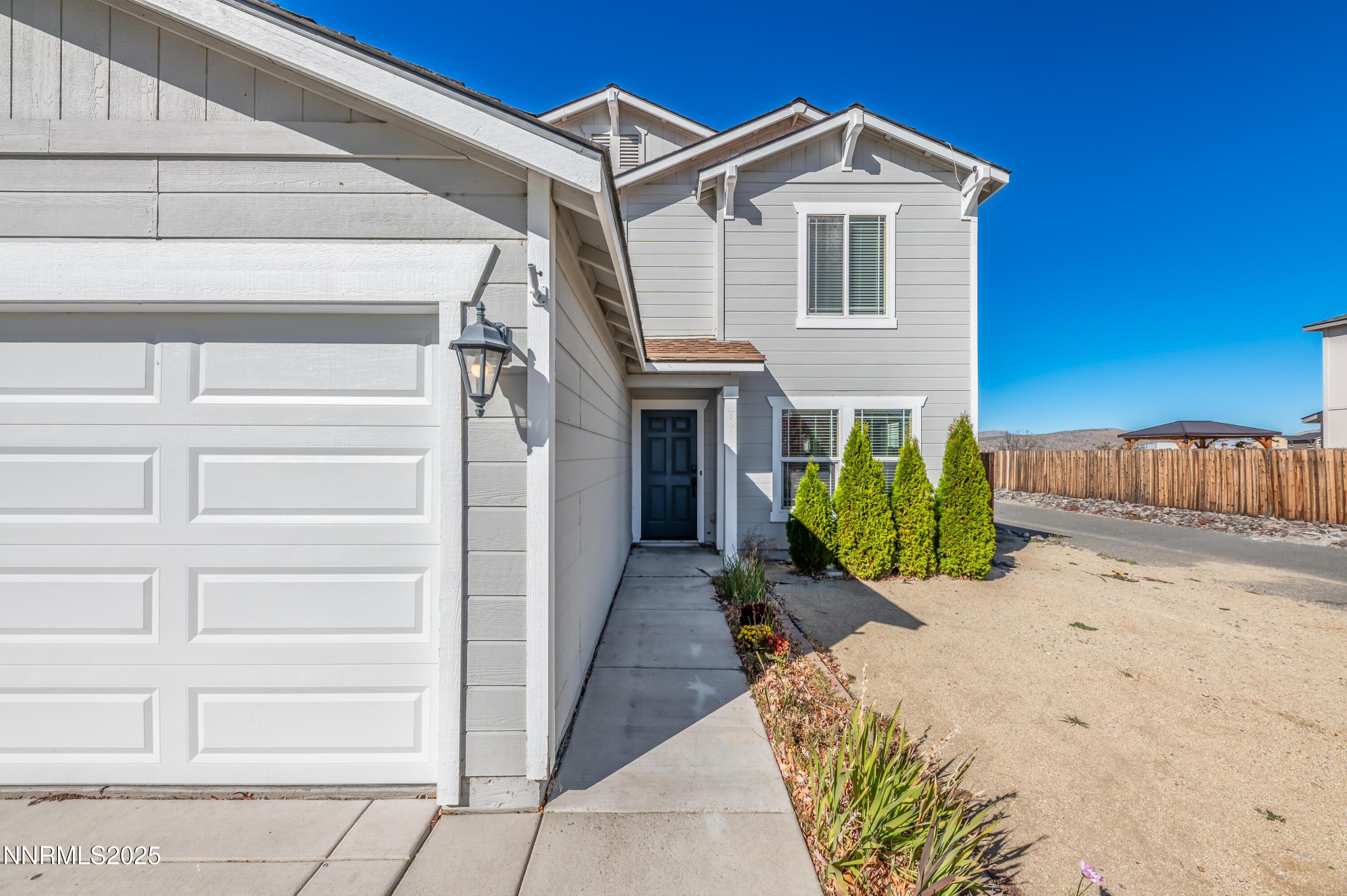 8905 Convair Way Reno, NV 89506 - Photo 5 of 38 a front view of a house with a yard