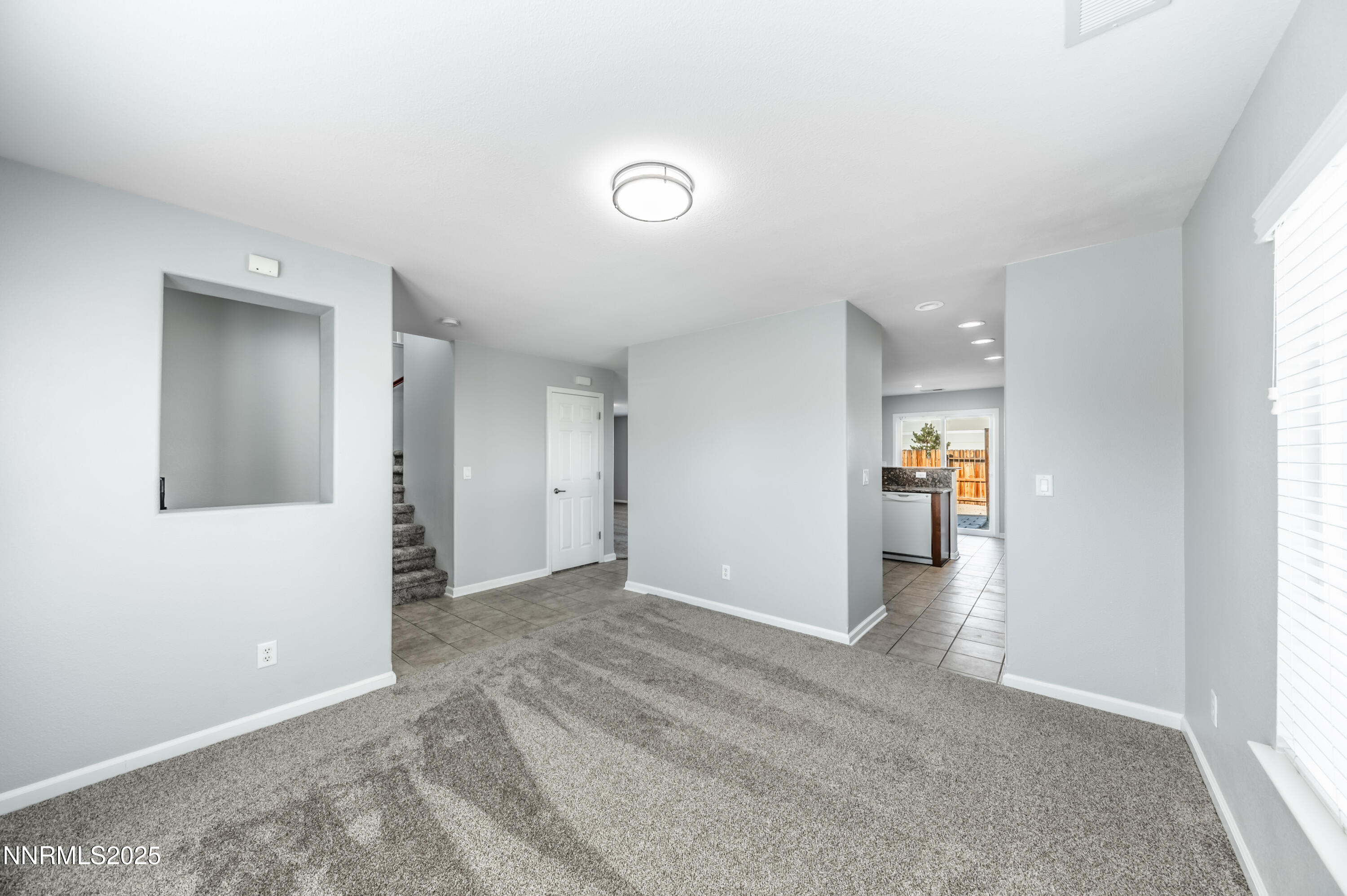 8905 Convair Way Reno, NV 89506 - Photo 9 of 38 an empty room with wooden floor and a window