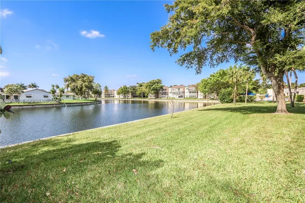 a view of a lake with houses in the back