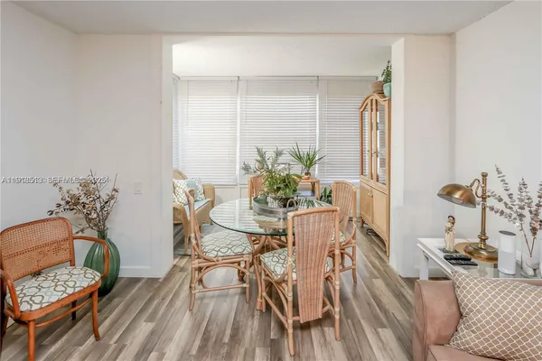 a view of a dining room with furniture and wooden floor