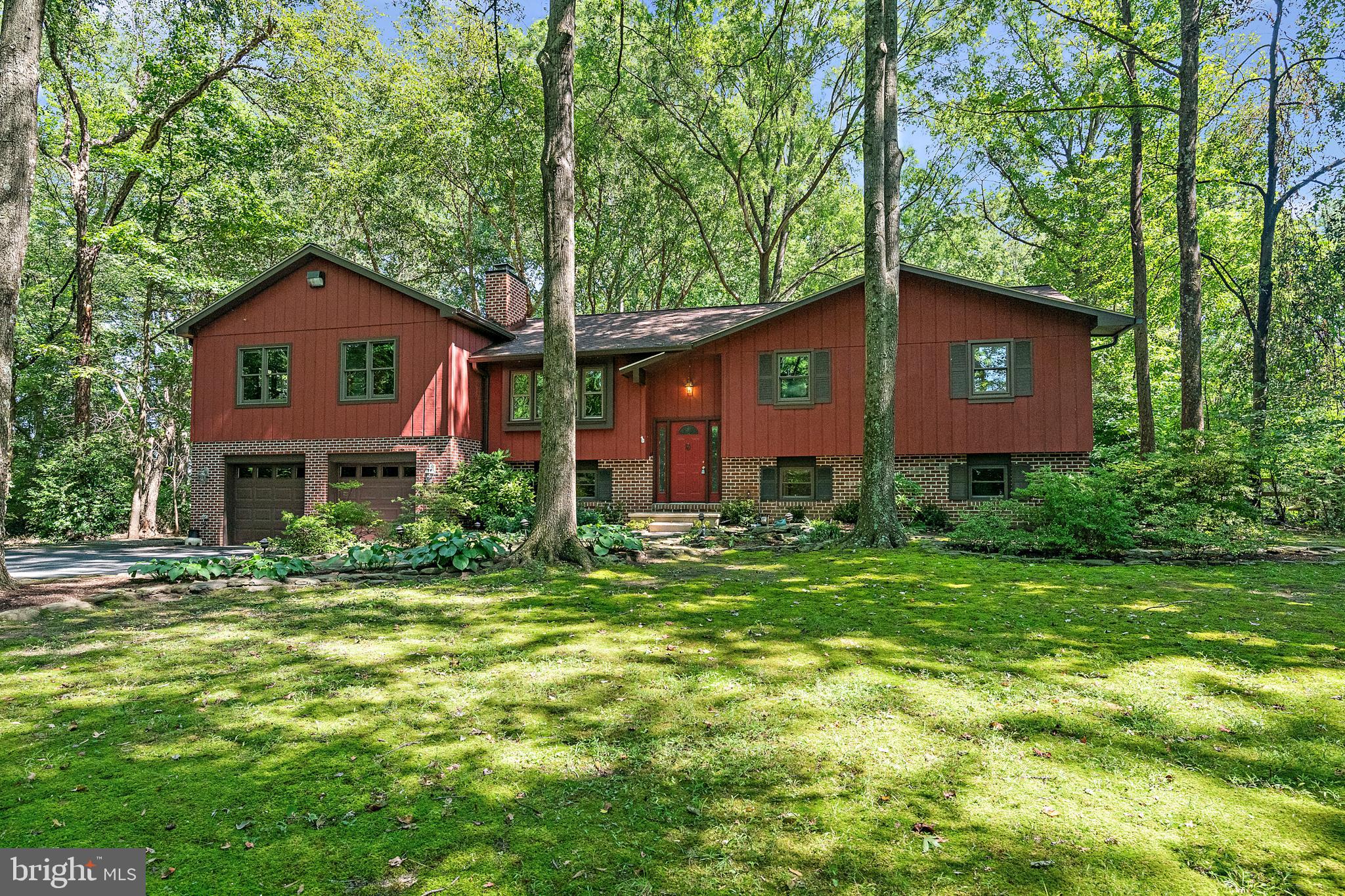 a red brick house with trees in front of it