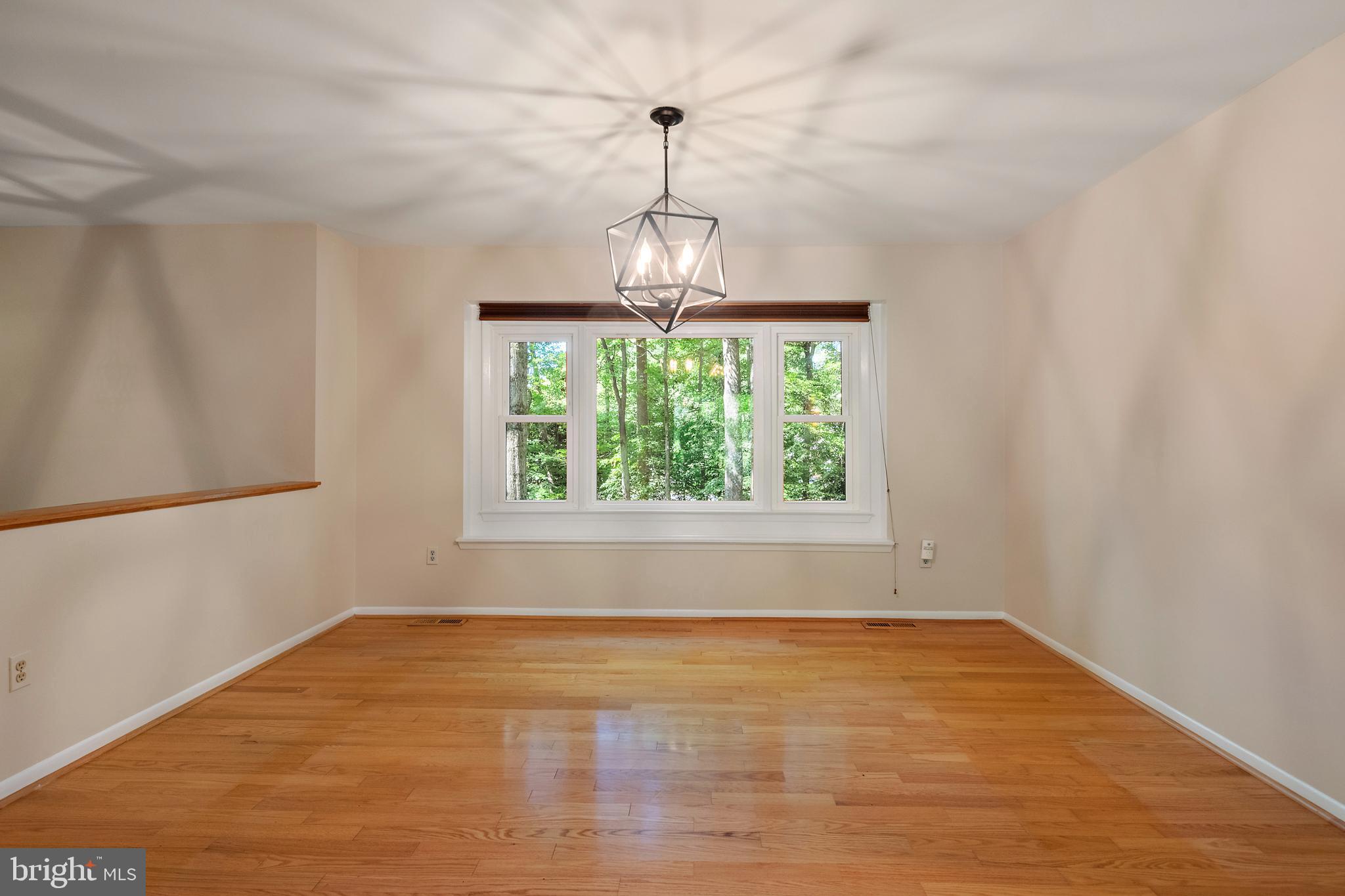 1701 Underwood Road Gambrills, MD 21054 - Photo 20 of 62 a big room with wooden floor a chandelier and windows