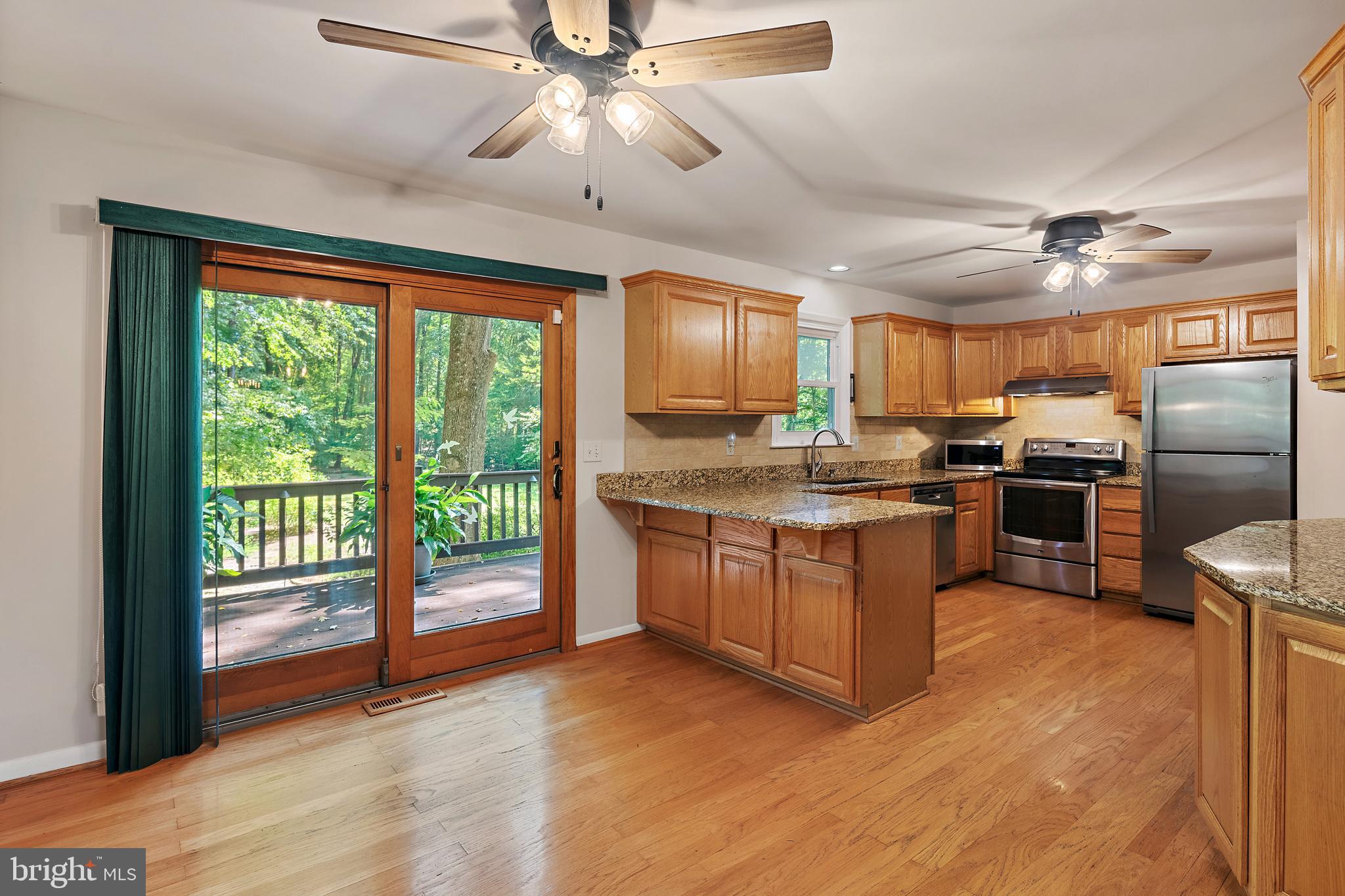 1701 Underwood Road Gambrills, MD 21054 - Photo 23 of 62 a kitchen with granite countertop stainless steel appliances a stove top oven a sink and cabinets