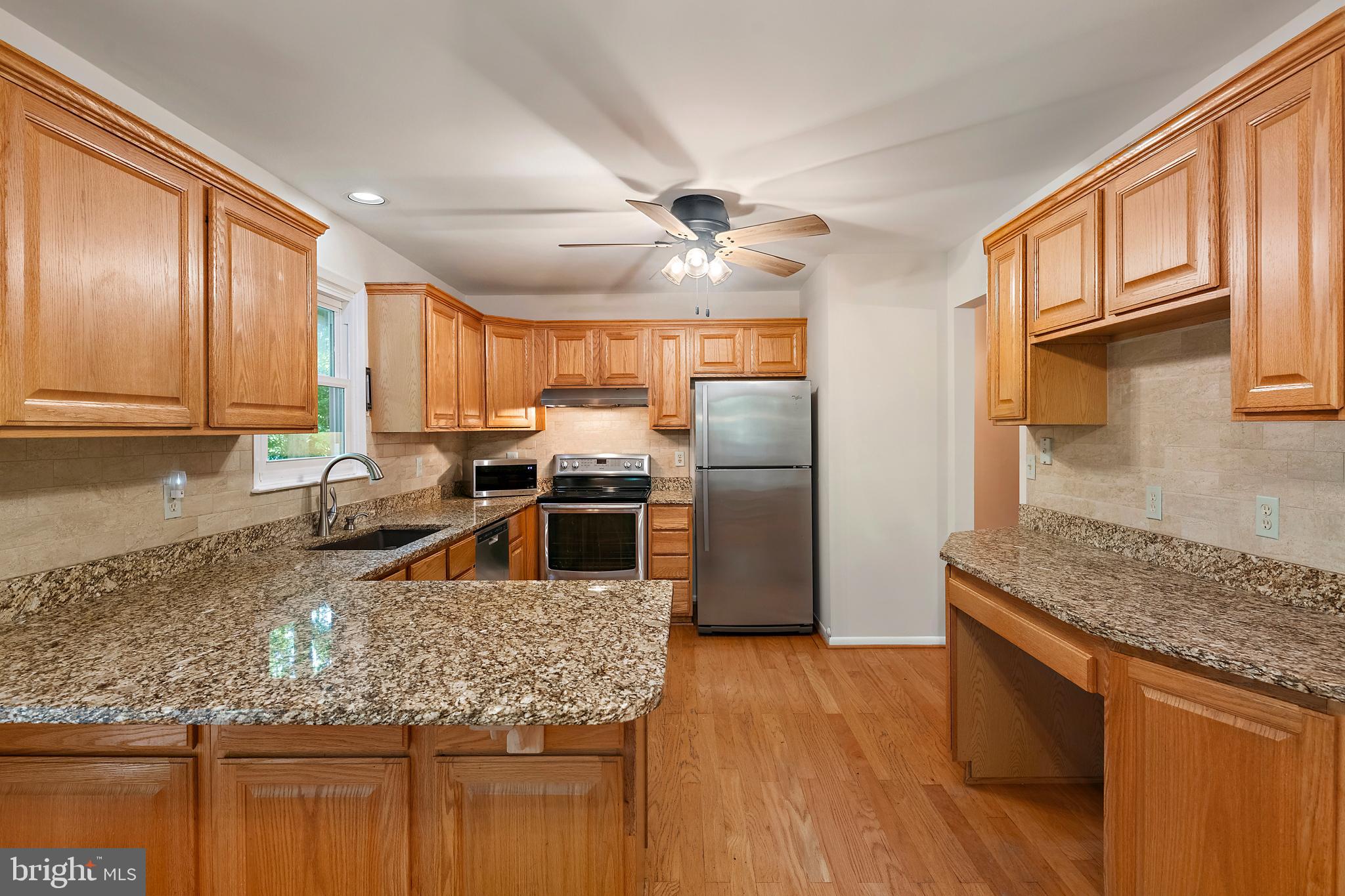1701 Underwood Road Gambrills, MD 21054 - Photo 31 of 62 a kitchen with stainless steel appliances granite countertop a stove a sink dishwasher a refrigerator and wooden cabinets with wooden floor