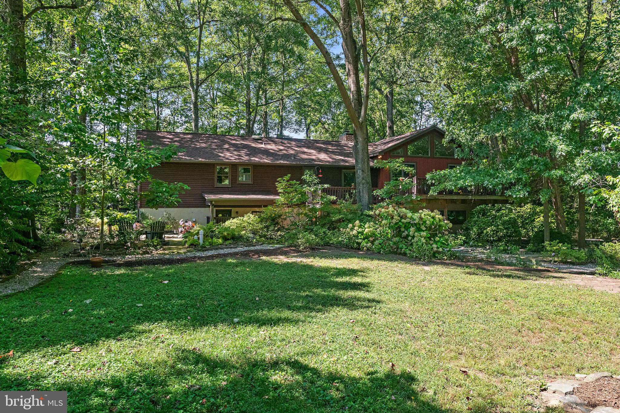 1701 Underwood Road Gambrills, MD 21054 - Photo 5 of 62 a view of a backyard with plants and large trees