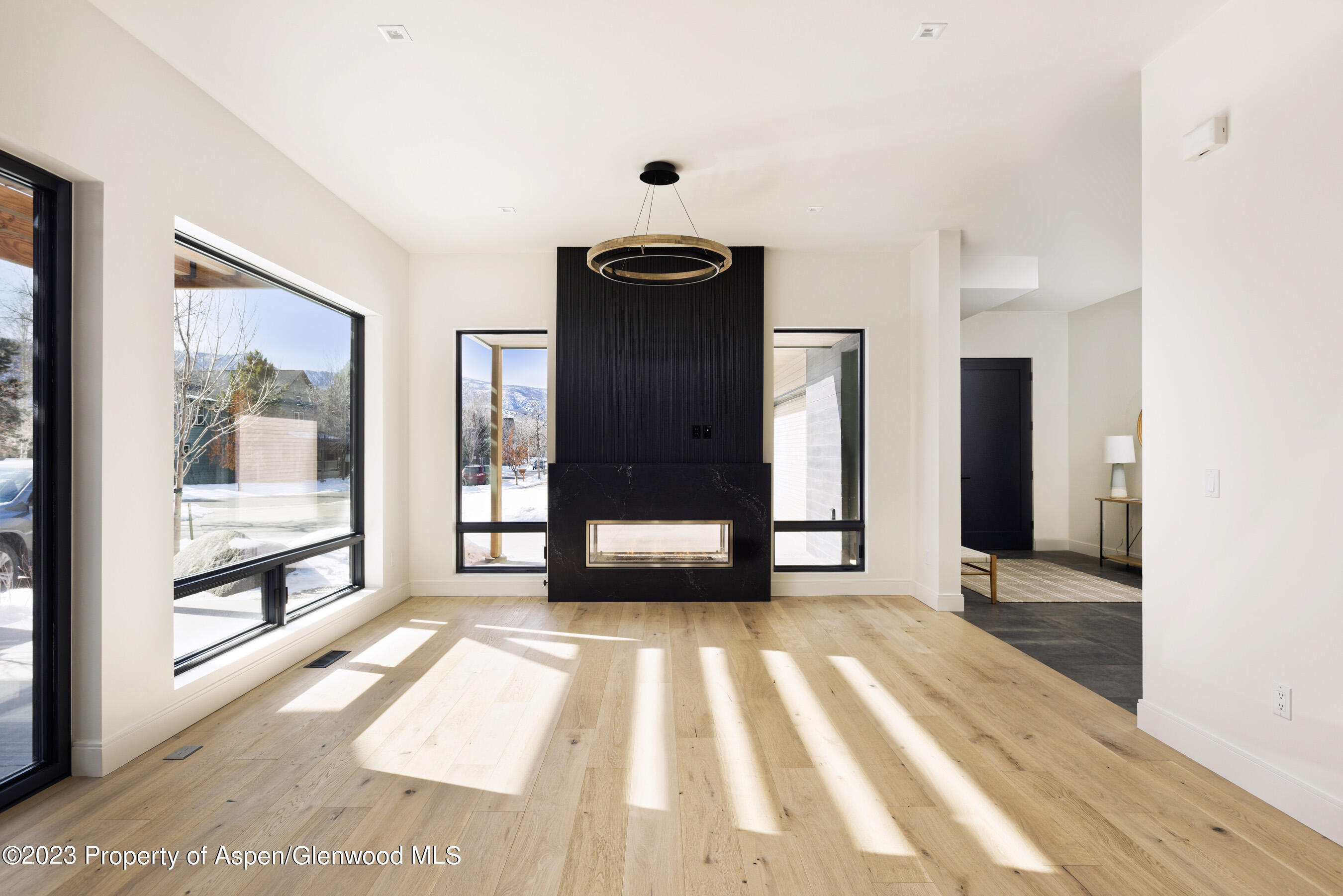 415 Meadow Court Basalt, CO 81621 - Photo 6 of 19 a view of a hallway with wooden floor and windows