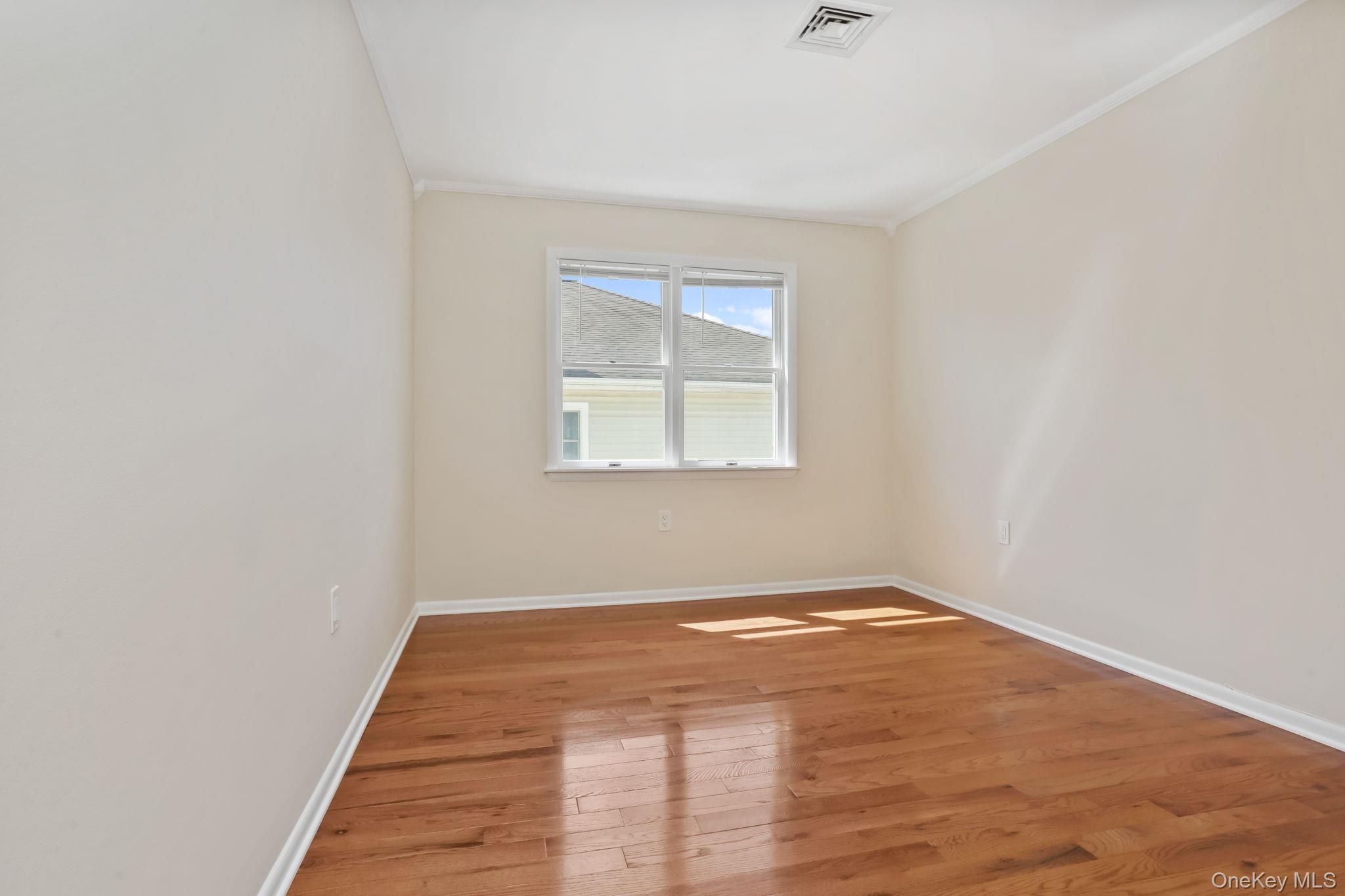 160 Lakeview Avenue, Unit 2 West Harrison, NY 10604 - Photo 15 of 19 an empty room with wooden floor and windows