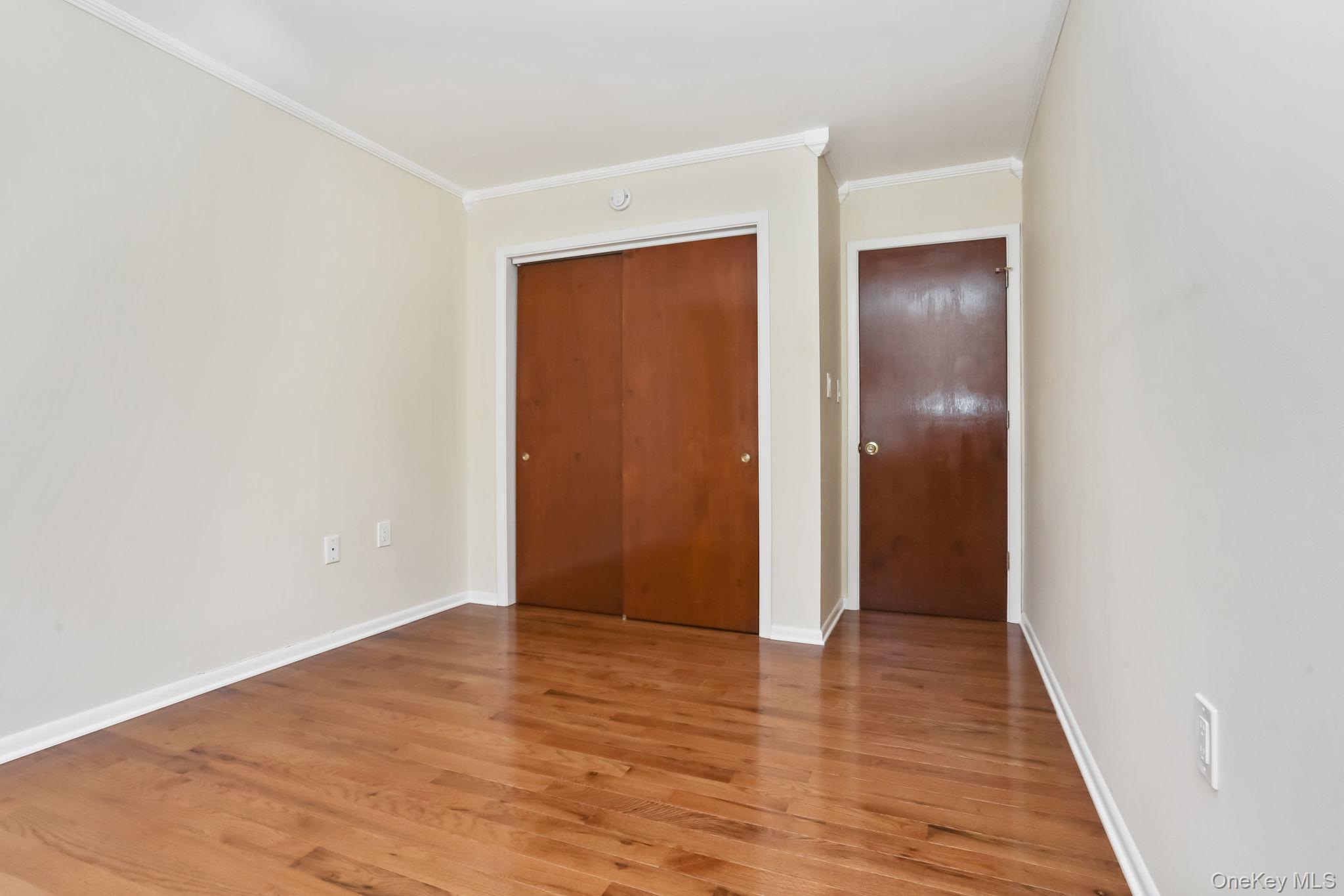 160 Lakeview Avenue, Unit 2 West Harrison, NY 10604 - Photo 16 of 19 an empty room with wooden floor and closet