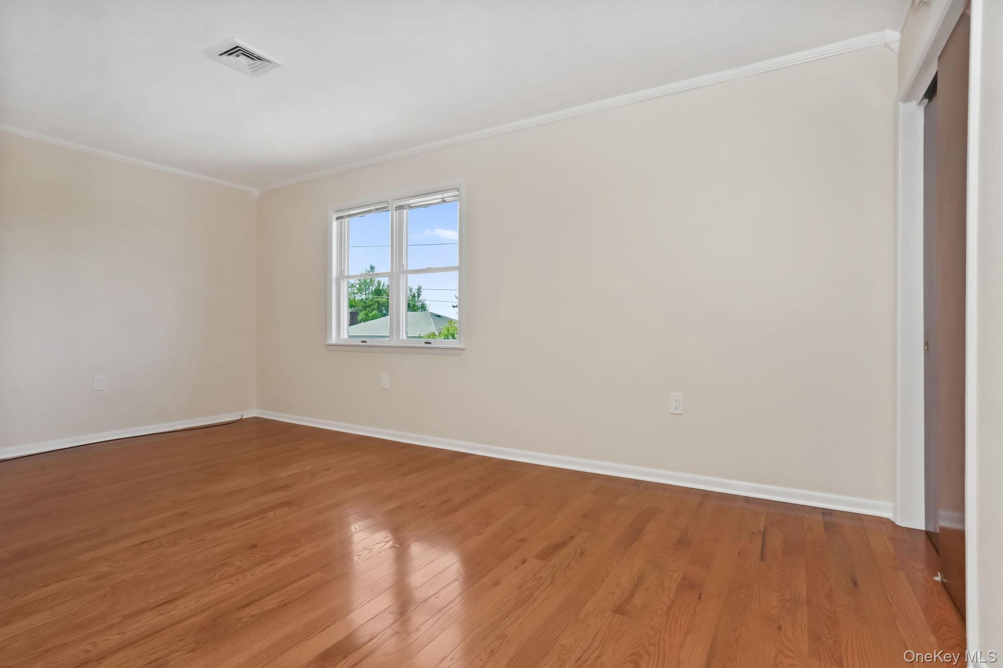 160 Lakeview Avenue, Unit 2 West Harrison, NY 10604 - Photo 17 of 19 an empty room with wooden floor and windows