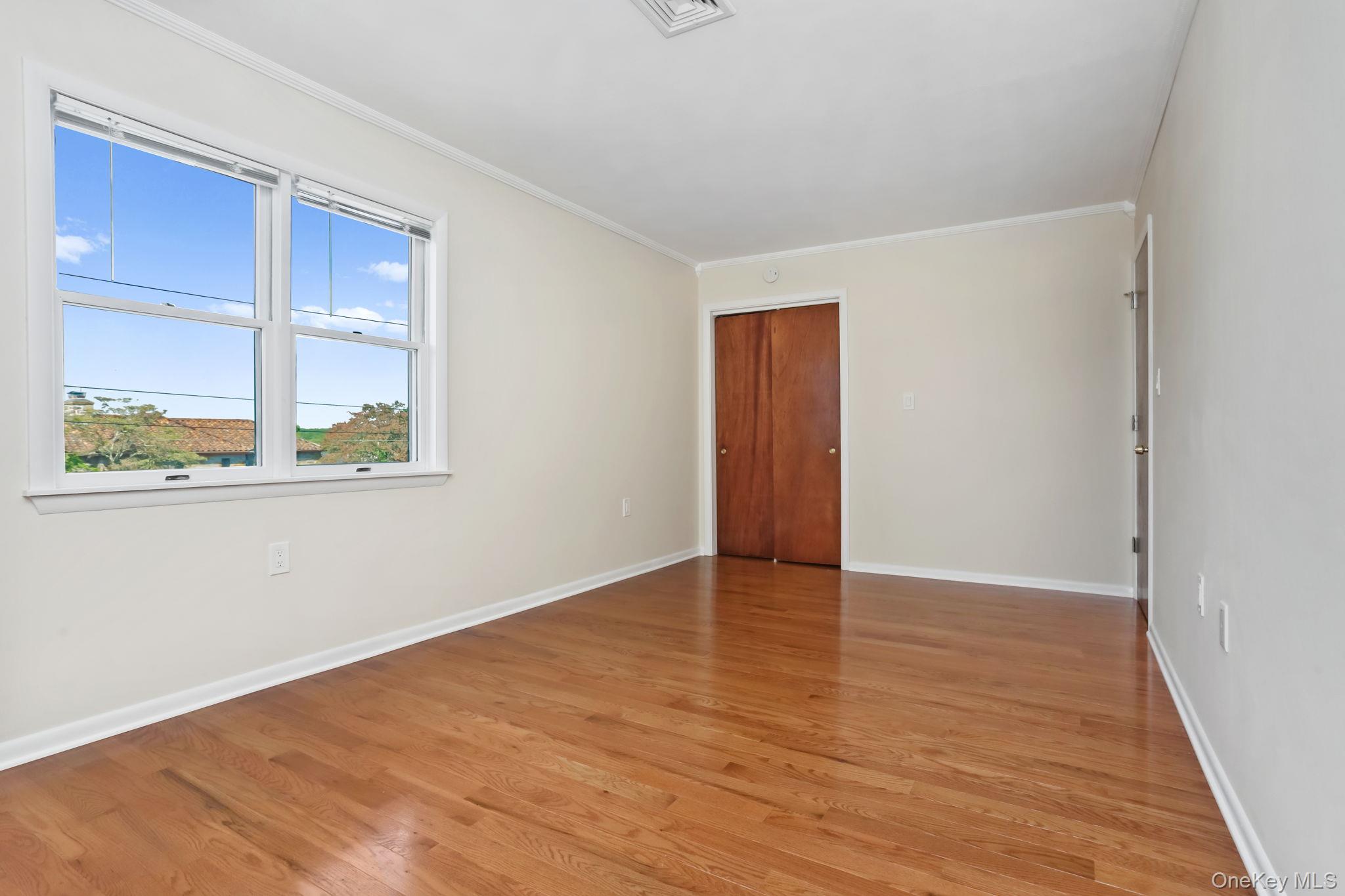 160 Lakeview Avenue, Unit 2 West Harrison, NY 10604 - Photo 18 of 19 an empty room with wooden floor and windows