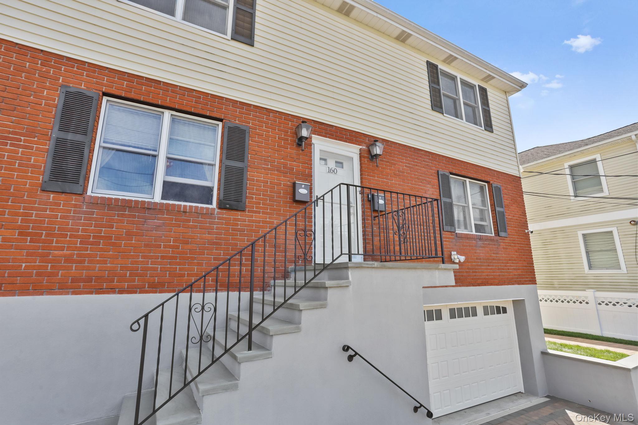 160 Lakeview Avenue, Unit 2 West Harrison, NY 10604 - Photo 2 of 19 a view of a house with wooden fence