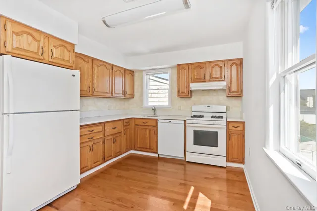 a kitchen with stainless steel appliances granite countertop a refrigerator a stove a sink and a microwave