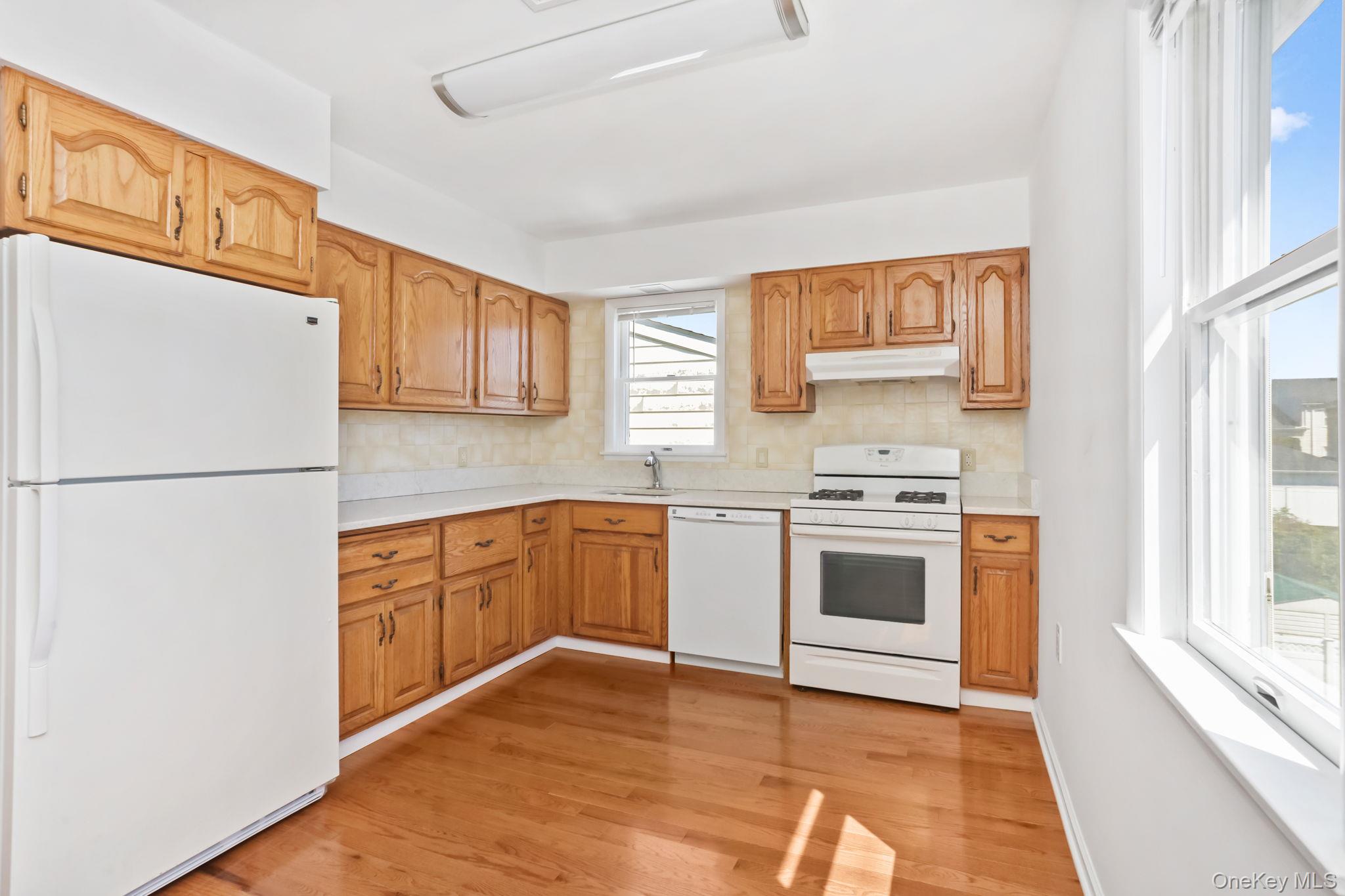 160 Lakeview Avenue, Unit 2 West Harrison, NY 10604 - Photo 8 of 19 a kitchen with stainless steel appliances granite countertop a refrigerator a stove a sink and a microwave