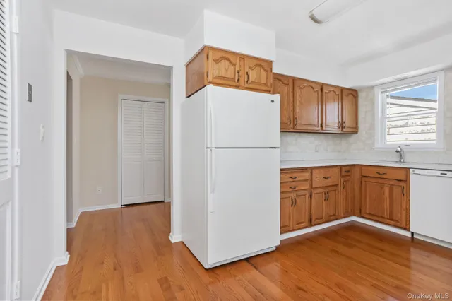 a kitchen with a refrigerator and a stove top oven