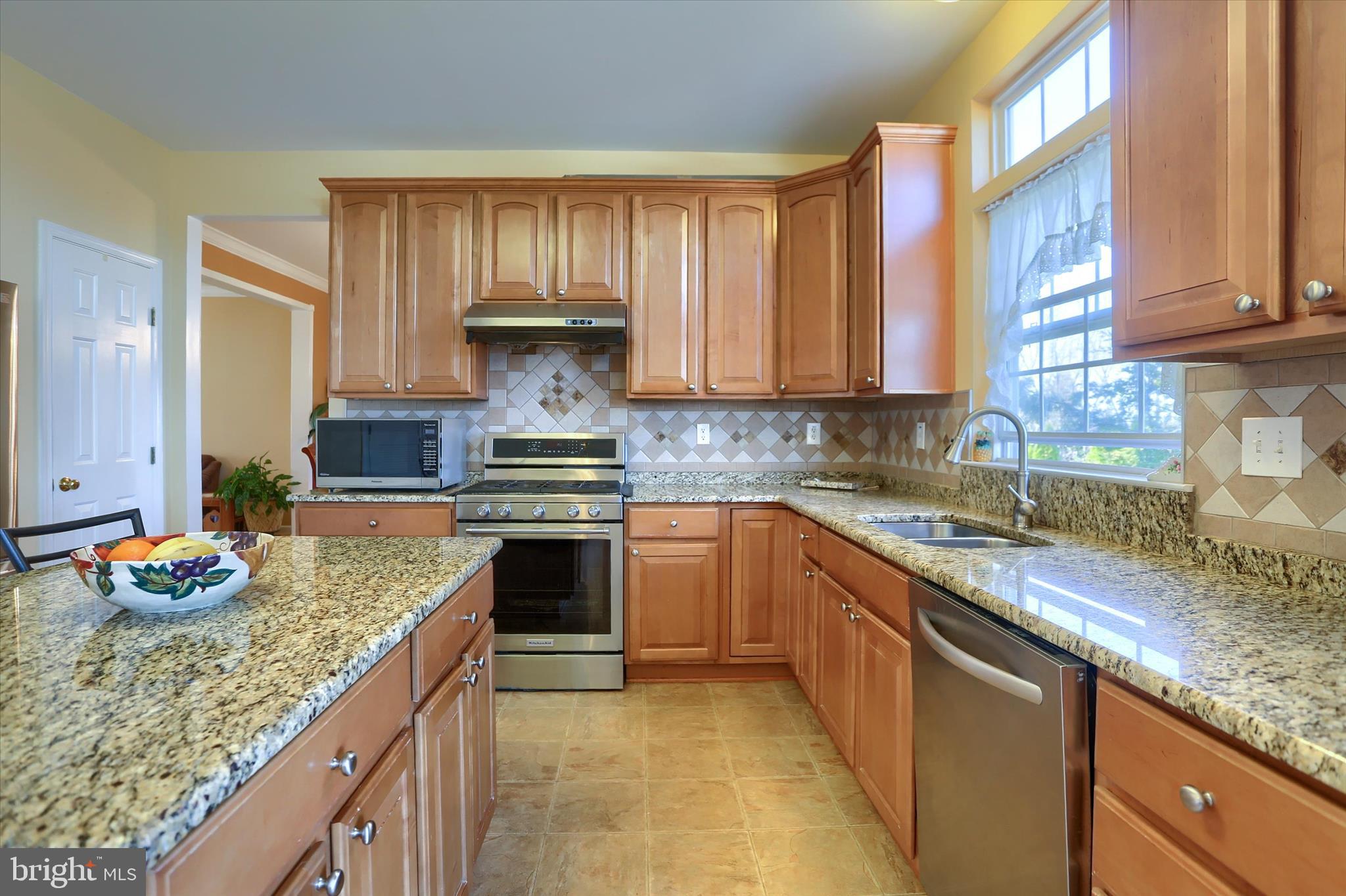 409 Wynwood Road York, PA 17402 - Photo 18 of 64 a kitchen with granite countertop a sink stove and cabinets