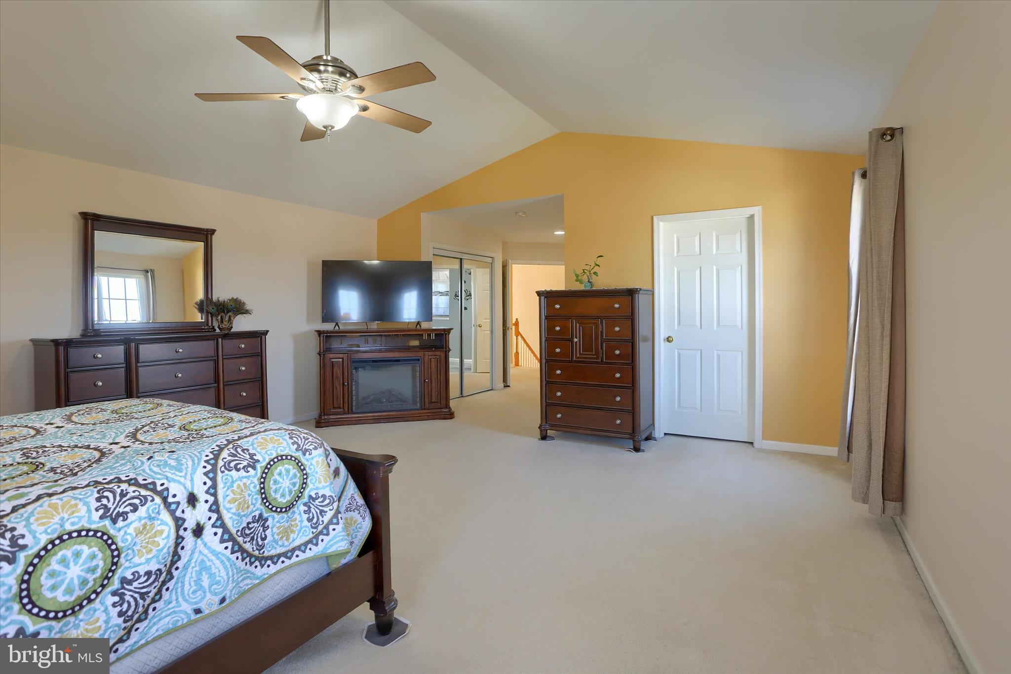 409 Wynwood Road York, PA 17402 - Photo 29 of 64 a spacious bedroom with a bed and a chandelier