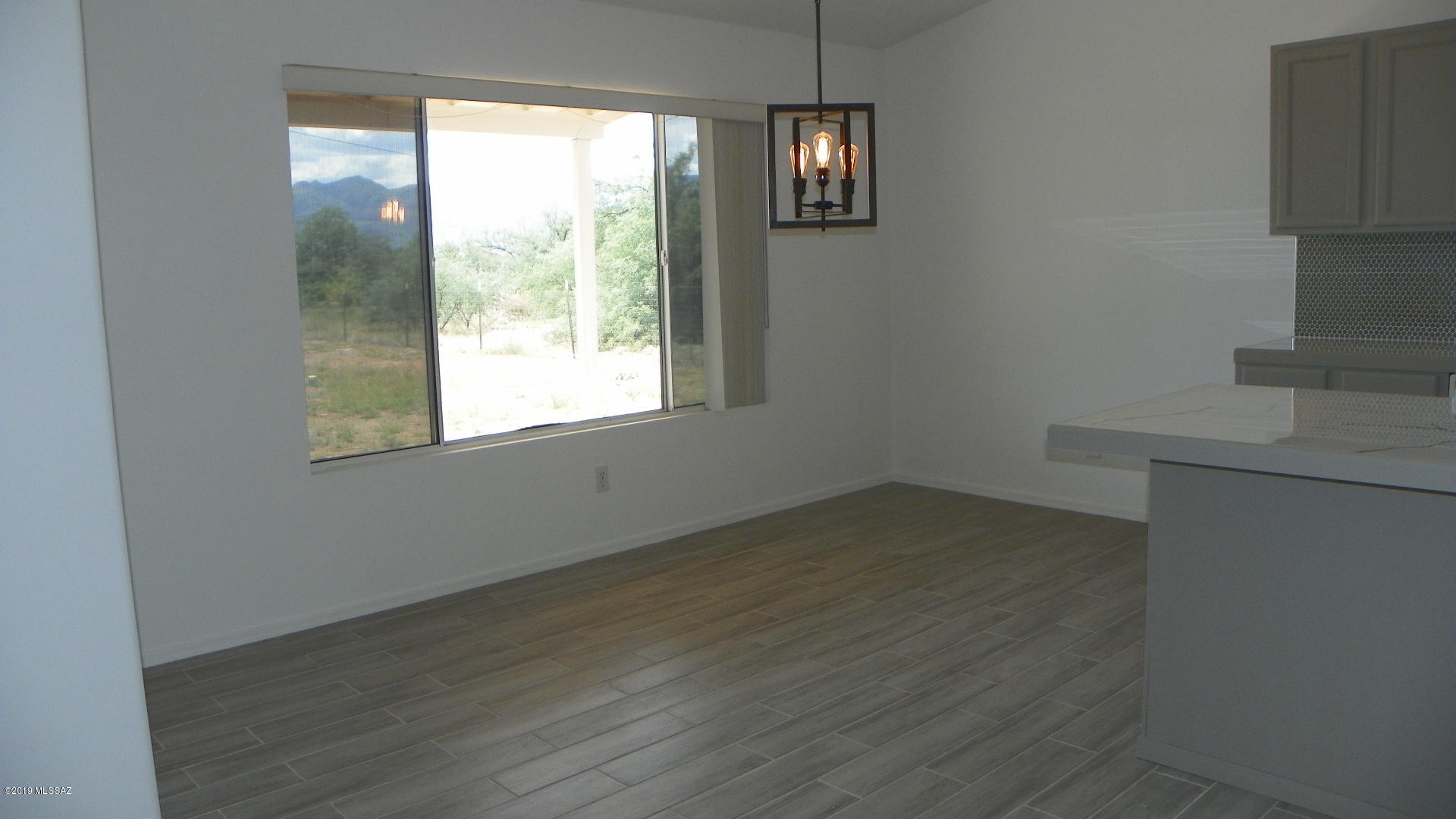 1731 Círculo Alameda Rio Rico, AZ 85648 - Photo 11 of 33 an empty room with wooden floor and windows