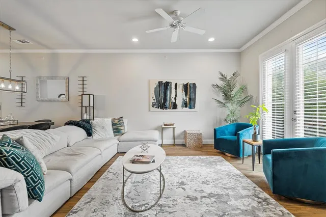 a living room with furniture and a potted plant