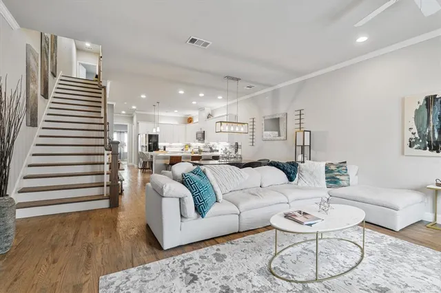 a living room with furniture kitchen view and a table