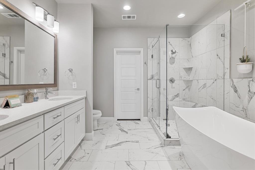 6013 Page Street Frisco, TX 75034 - Photo 28 of 39 a bathroom with a sink a toilet and shower
