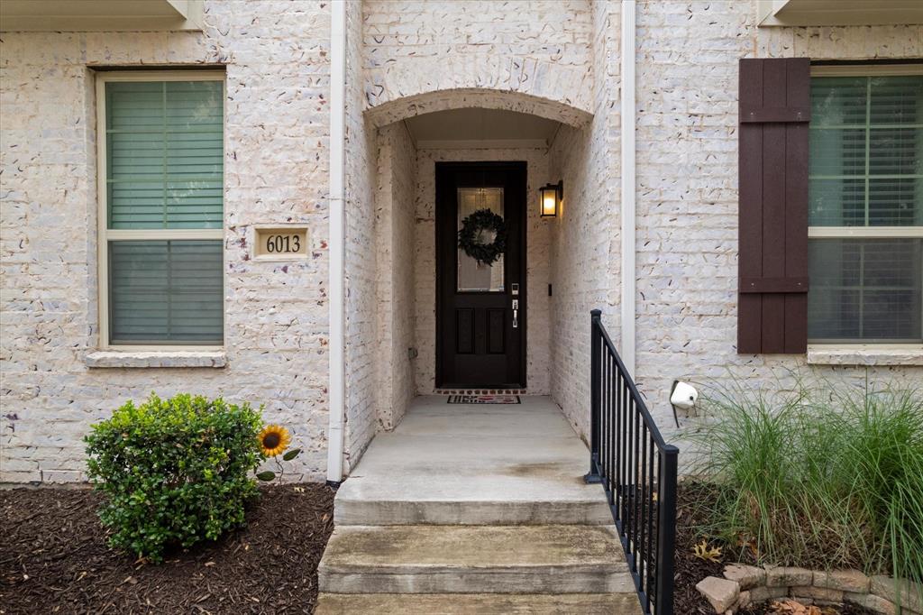 6013 Page Street Frisco, TX 75034 - Photo 5 of 39 a entryway with flower pots