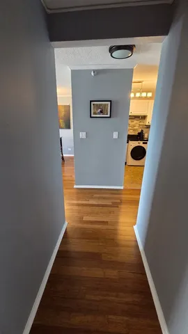 a view of a big room with wooden floor and windows