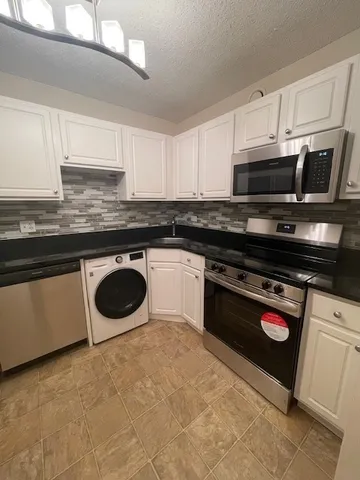 a kitchen with stainless steel appliances a stove and a refrigerator