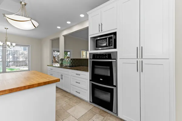 a kitchen with stainless steel appliances granite countertop a refrigerator and a stove