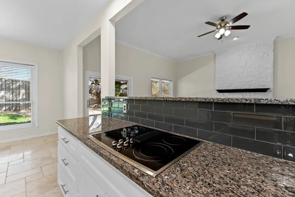 a kitchen with a sink stove and cabinets