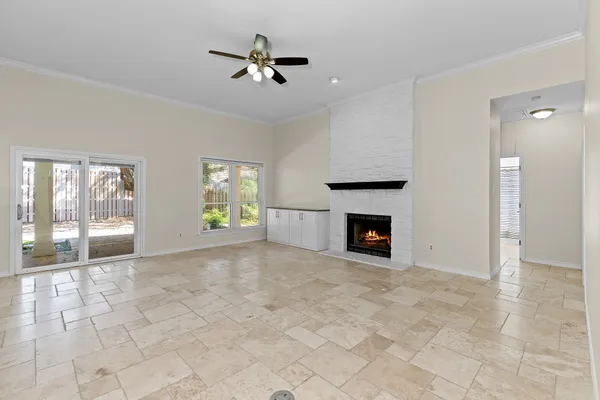 a view of an empty room with a fireplace and a window